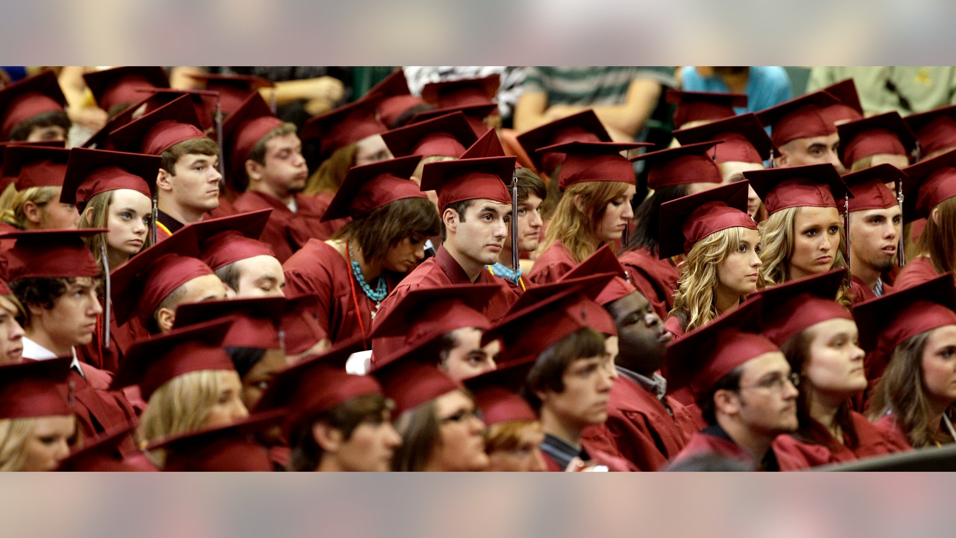 Members of the class of 2012 listen as President Barack Obama delivers the commencement address for Joplin High School Monday, May 21, 2012, in Joplin, Mo. Seniors at the school finished their high school education in a converted big-box store after the old high school was destroyed by an EF-5 tornado that killed 161 people on graduation day a year ago. (AP Photo/Charlie Riedel)