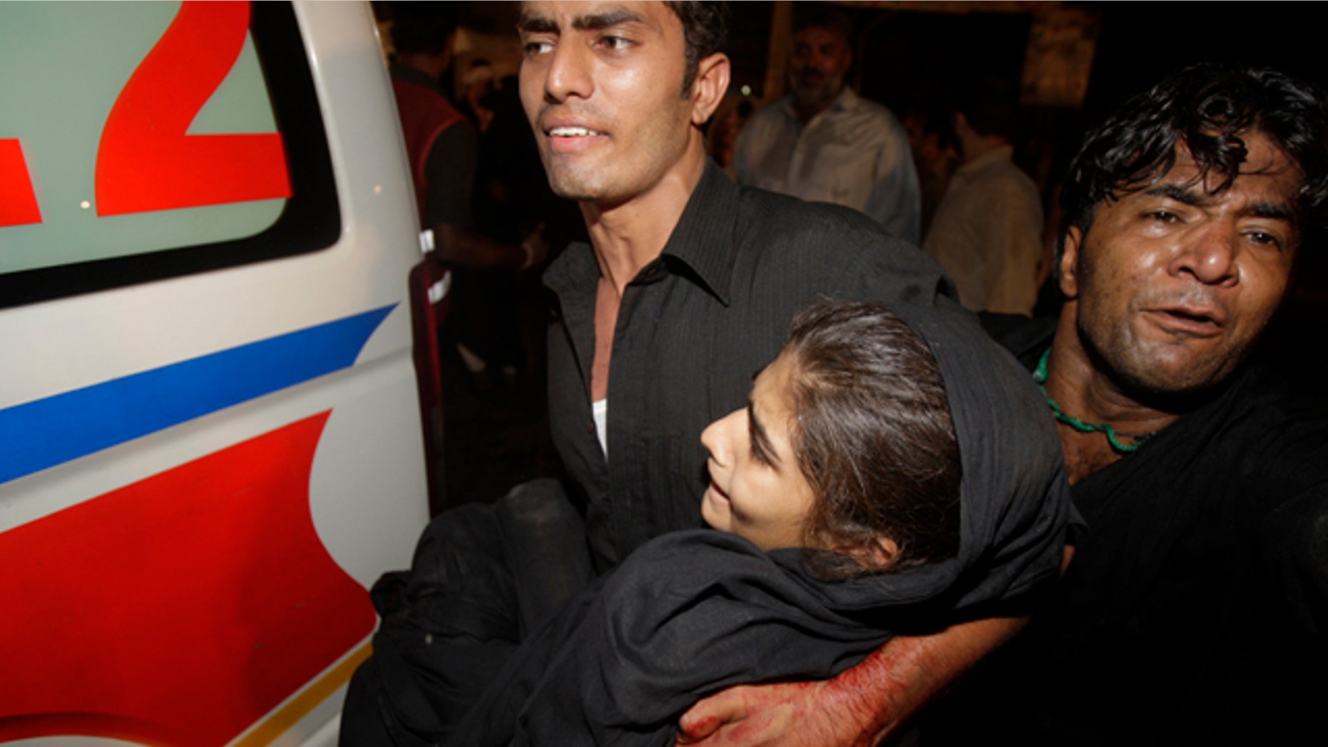 Sept. 1: Volunteers carry an injured girl to an ambulance after blasts in Lahore, Pakistan.