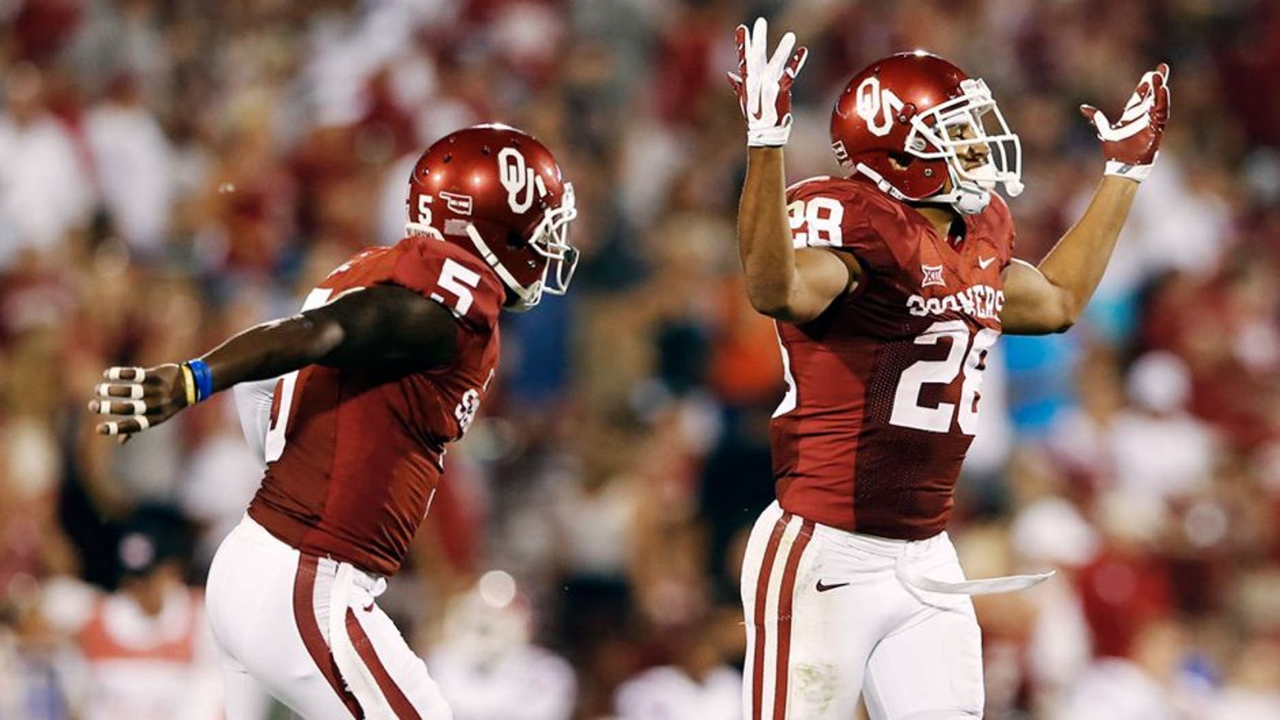 Aug 30, 2014; Norman, OK, USA; Oklahoma Sooners running back Alex Ross (28) celebrates with wide receiver Durron Neal (5) after returning a long punt during the game against the Louisiana Tech Bulldogs at Gaylord Family - Oklahoma Memorial Stadium. Mandatory Credit: Kevin Jairaj-USA TODAY Sports