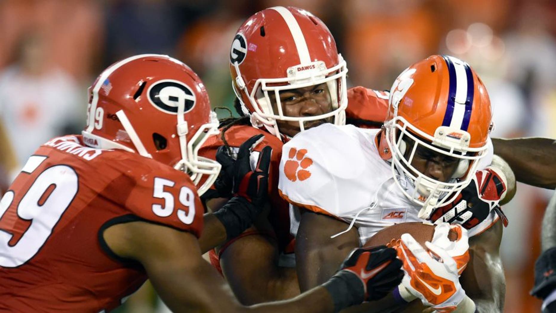 Aug 30, 2014; Athens, GA, USA; Clemson Tigers running back D.J. Howard (22) is tackled by Georgia Bulldogs linebacker Jordan Jenkins (59) and linebacker Ramik Wilson (51) during the second half at Sanford Stadium. Georgia defeated Clemson 45-21. Mandatory Credit: Dale Zanine-USA TODAY Sports