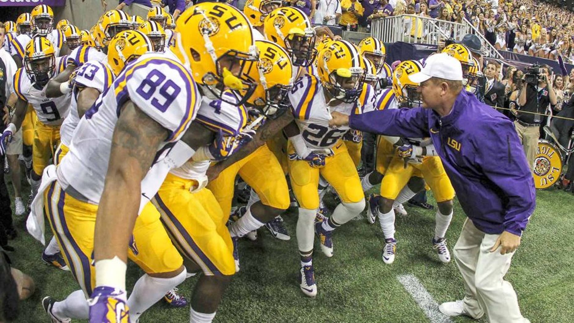 Aug 30, 2014; Houston, TX, USA; LSU Tigers head coach Les Miles leads the team onto the field before a game against the Wisconsin Badgers at NRG Stadium. Mandatory Credit: Troy Taormina-USA TODAY Sports