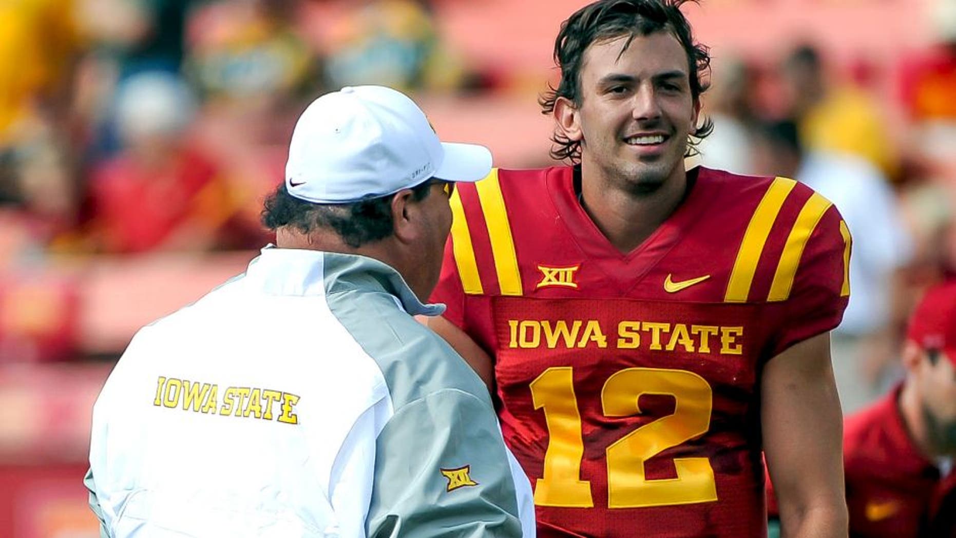 Aug 30, 2014; Ames, IA, USA; Iowa State Cyclones offensive coordinator Mark Mangino talks with quarterback Sam B. Richardson (12) prior to the game against the North Dakota State Bison at Jack Trice Stadium. North Dakota State defeated Iowa State 34-14. Mandatory Credit: Steven Branscombe-USA TODAY Sports
