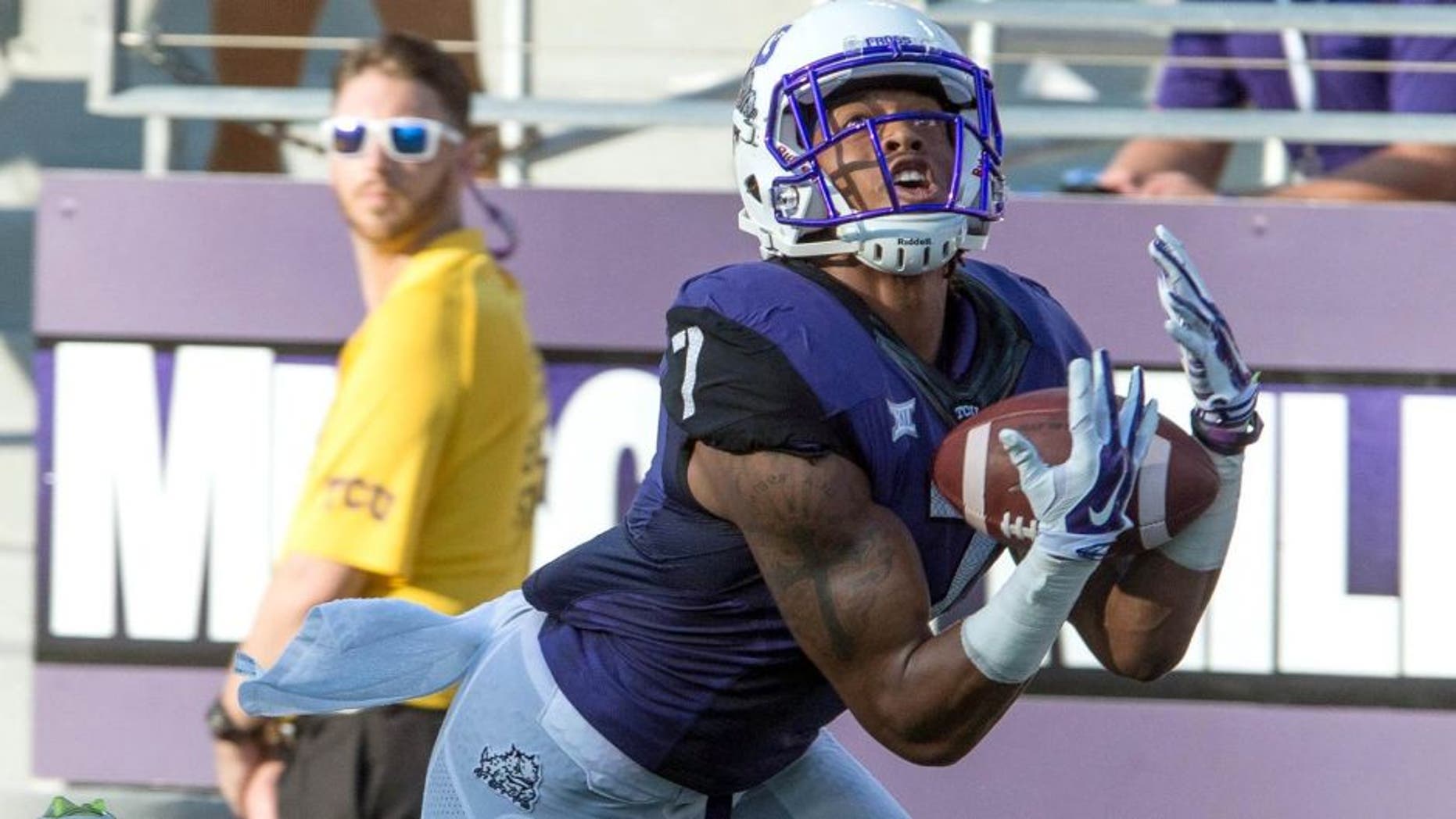 Aug 30, 2014; Fort Worth, TX, USA; TCU Horned Frogs wide receiver Kolby Listenbee (7) catches a touchdown pass as Samford Bulldogs defensive back James Bradberry (21) defends during the first quarter at Amon G. Carter Stadium. Mandatory Credit: Jerome Miron-USA TODAY Sports