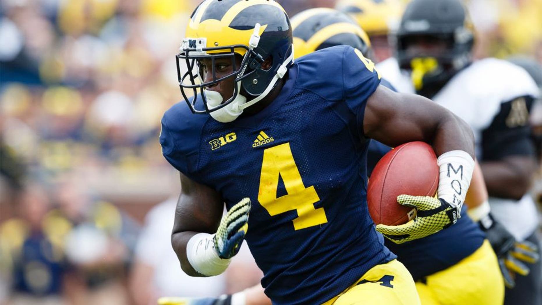 Aug 30, 2014; Ann Arbor, MI, USA; Michigan Wolverines running back De'Veon Smith (4) rushes for a touchdown in the third quarter against the Appalachian State Mountaineers at Michigan Stadium. Michigan won 52-14. Mandatory Credit: Rick Osentoski-USA TODAY Sports