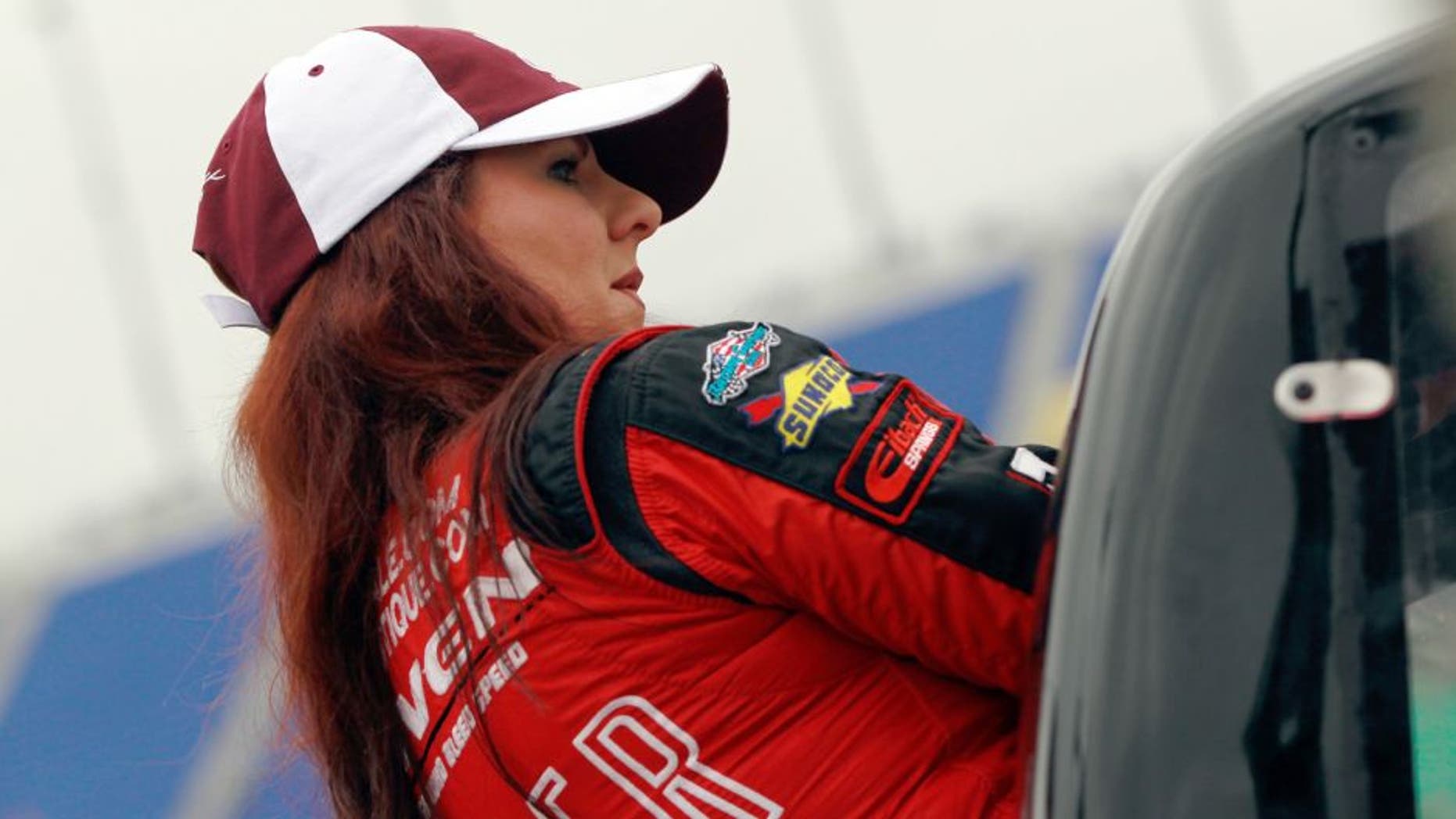 KANSAS CITY, KS - MAY 08: Jennifer Jo Cobb, driver of the #10 Mark One Electric Chevrolet, gets in her truck during qualifying for the NASCAR Camping World Truck Series Toyota Tundra 250 at Kansas Speedway on May 8, 2015 in Kansas City, Kansas. (Photo by Brian Lawdermilk/NASCAR via Getty Images)