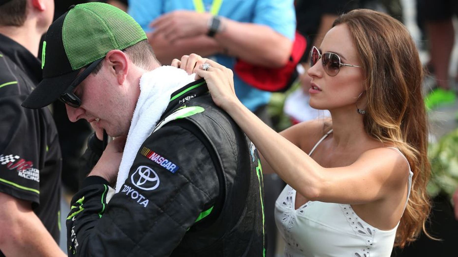 INDIANAPOLIS, IN - JULY 25: Kyle Busch, driver of the #54 Monster Energy Toyota, is assisted by his wife Samantha as he tries to cool off following the NASCAR XFINITY Series Lilly Diabetes 250 at Indianapolis Motor Speedway on July 25, 2015 in Indianapolis, Indiana. (Photo by Brian Lawdermilk/Getty Images)