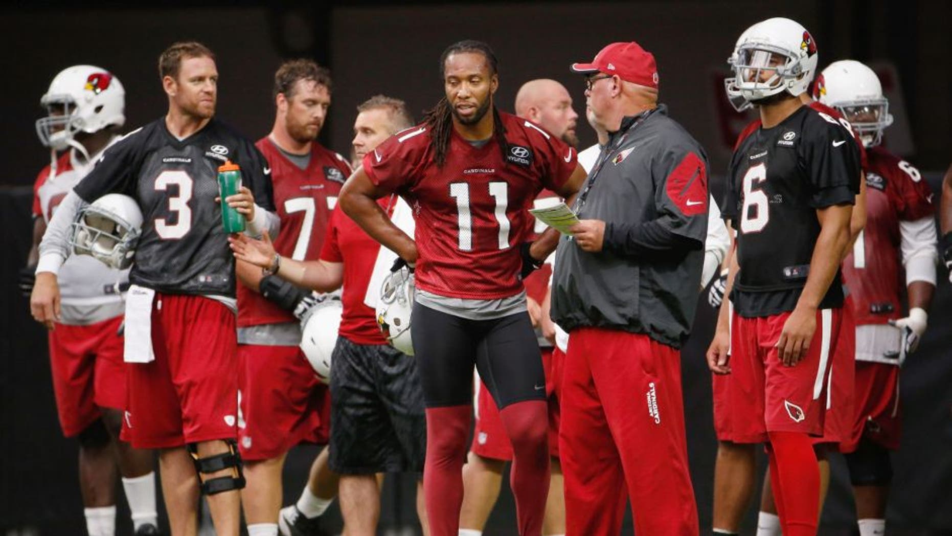 GLENDALE, AZ - AUGUST 02: (L-R) Carson Palmer #3, Larry Fitzgerald #11, Bruce Arians and Logan Thomas #6 of the Arizona Cardinals stand on the field during the team training camp at University of Phoenix Stadium on August 2, 2015 in Glendale, Arizona. (Photo by Christian Petersen/Getty Images)