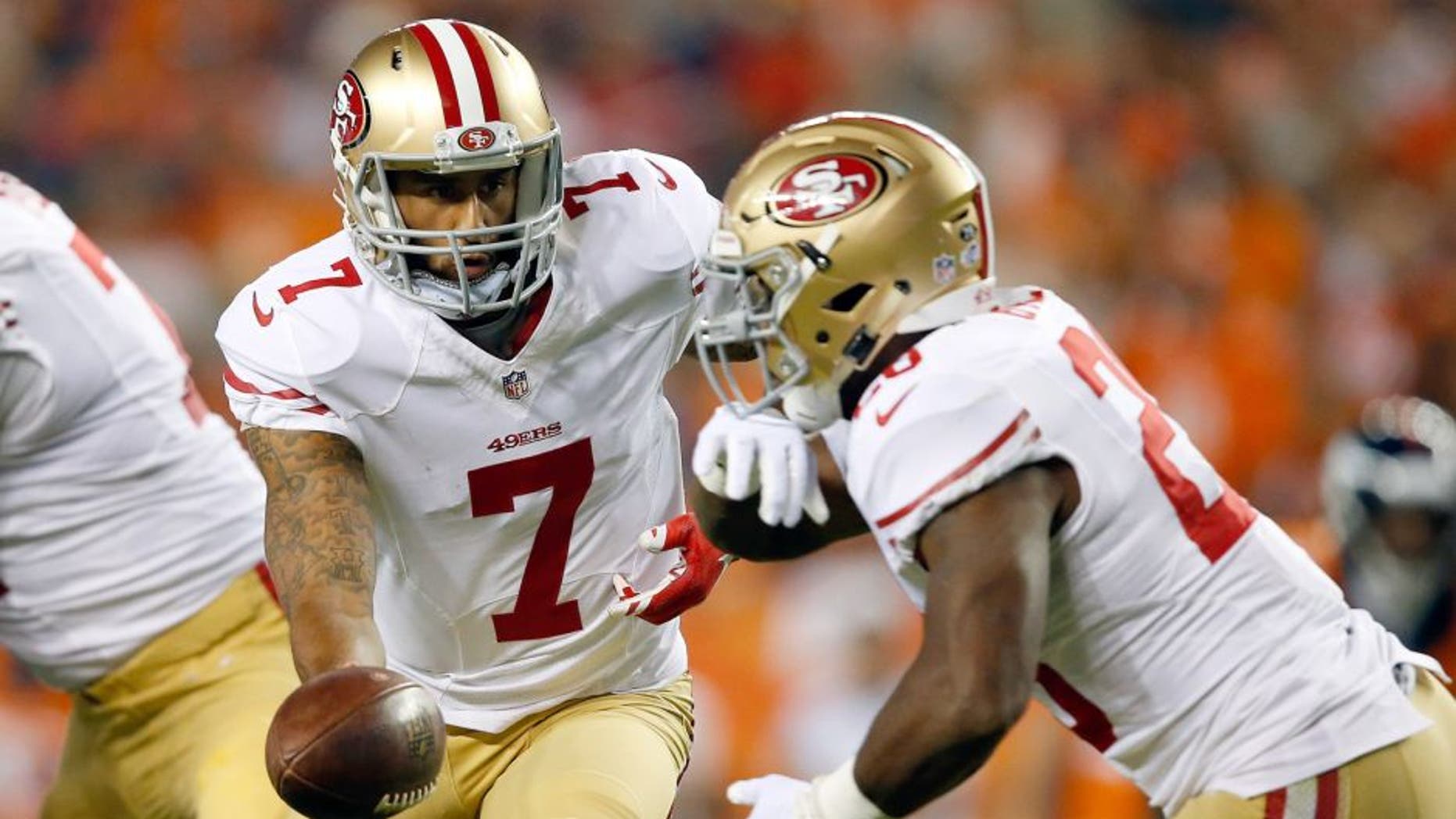 DENVER, CO - AUGUST 29: Quarterback Colin Kaepernick #7 of the San Francisco 49ers hands the ball off to running back Carlos Hyde #28 of the San Francisco 49ers against the Denver Broncos during preseason action at Sports Authority Field at Mile High on August 29, 2015 in Denver, Colorado. (Photo by Doug Pensinger/Getty Images)