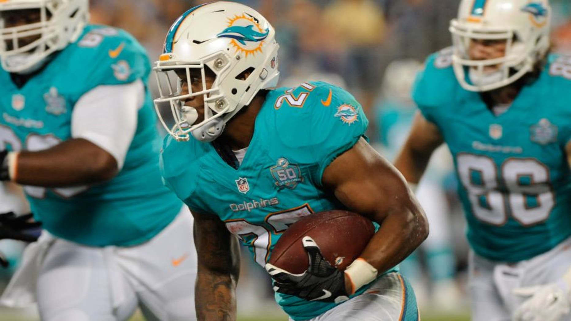 Aug 22, 2015; Charlotte, NC, USA; Miami Dolphins running back LaMichael James (27) returns a punt during the first half of the game against the Carolina Panthers at Bank of America Stadium. Mandatory Credit: Sam Sharpe-USA TODAY Sports