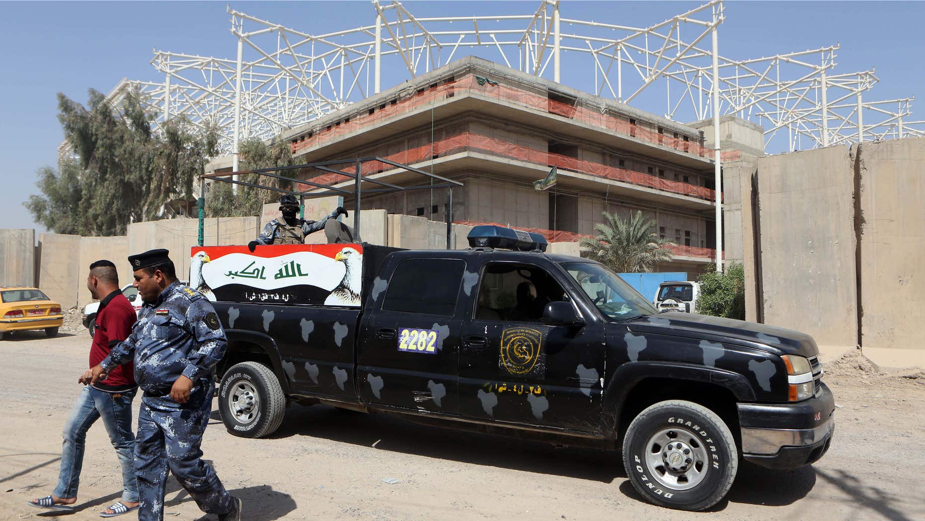 Sept. 2, 2015: Iraqi security forces guard the entrance to a sports complex being built by a Turkish construction company, in the Shiite district of Sadr City, Baghdad, Iraq.