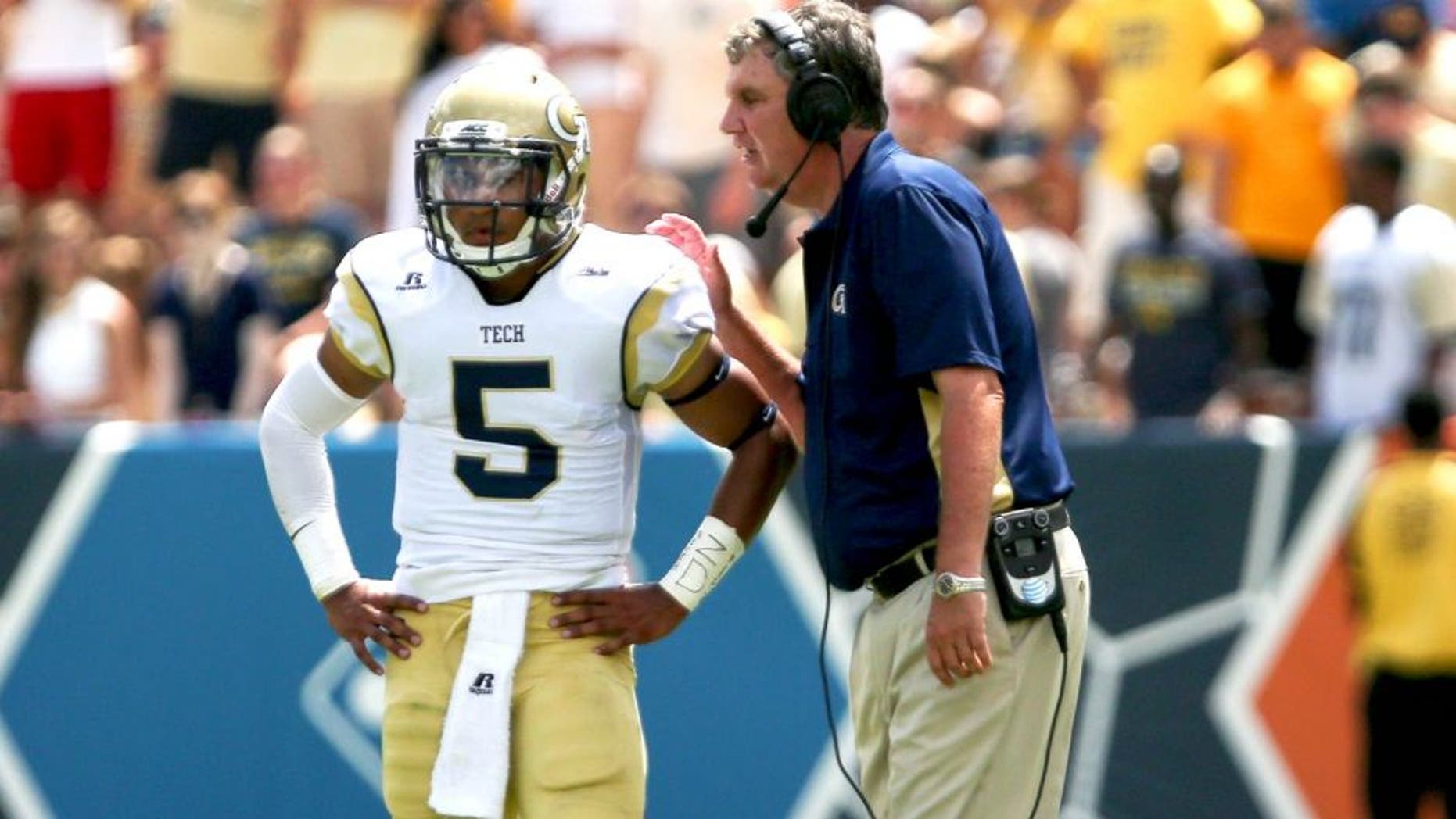 Aug 30, 2014; Atlanta, GA, USA; Georgia Tech Yellow Jackets head coach Paul Johnson talks with quarterback Justin Thomas (5) during the second quarter at Bobby Dodd Stadium. Georgia Tech won 38-19. Mandatory Credit: Kevin Liles-USA TODAY Sports