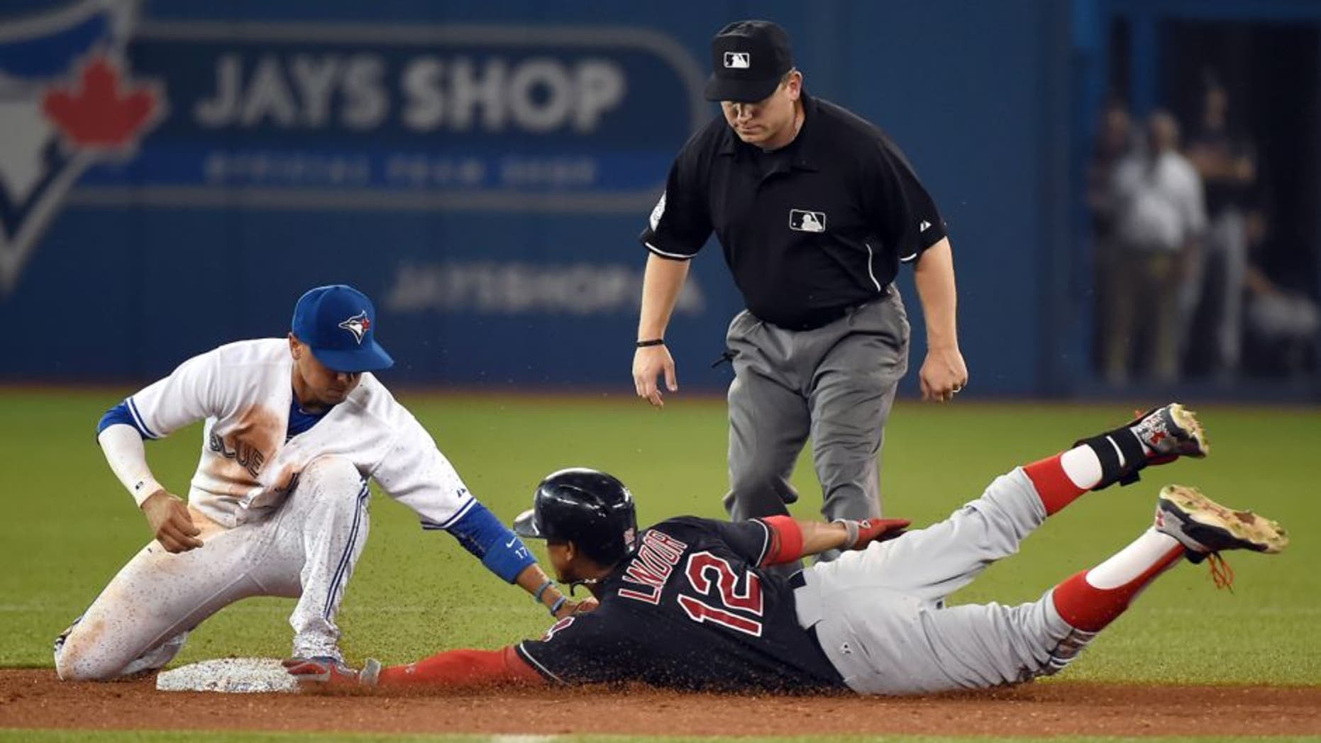 Sep 1, 2015; Toronto, Ontario, CAN; Cleveland Indians shortstop Francisco Lindor (12) slides safely into second with a double ahead of a tag from Toronto Blue Jays second baseman Ryan Goins (17) in the ninth inning at Rogers Centre.The Jays won 5-3. Mandatory Credit: Dan Hamilton-USA TODAY Sports