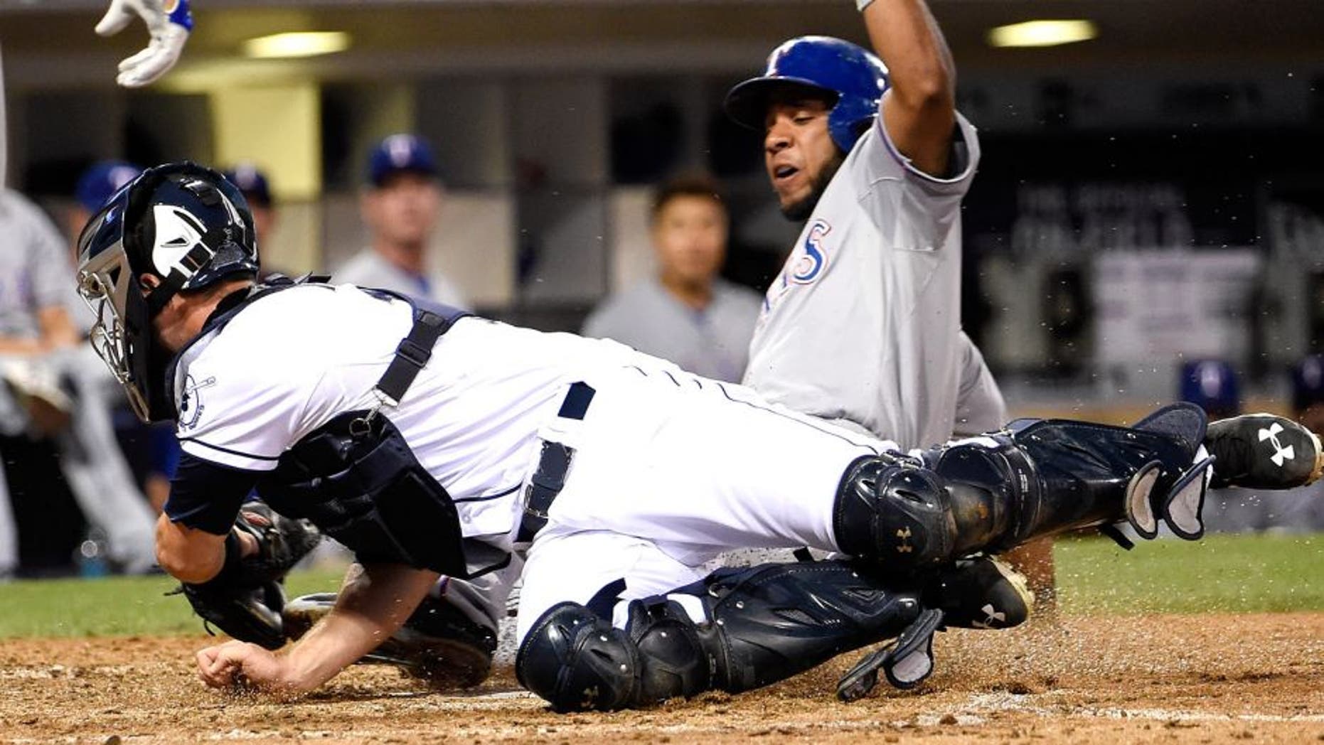 SAN DIEGO, CA - SEPTEMBER 1: Elvis Andrus #1 of the Texas Rangers steals home ahead of the tag of Austin Hedges #18 of the San Diego Padres during the seventh inning of a baseball game at Petco Park September, 1, 2015 in San Diego, California. (Photo by Denis Poroy/Getty Images)
