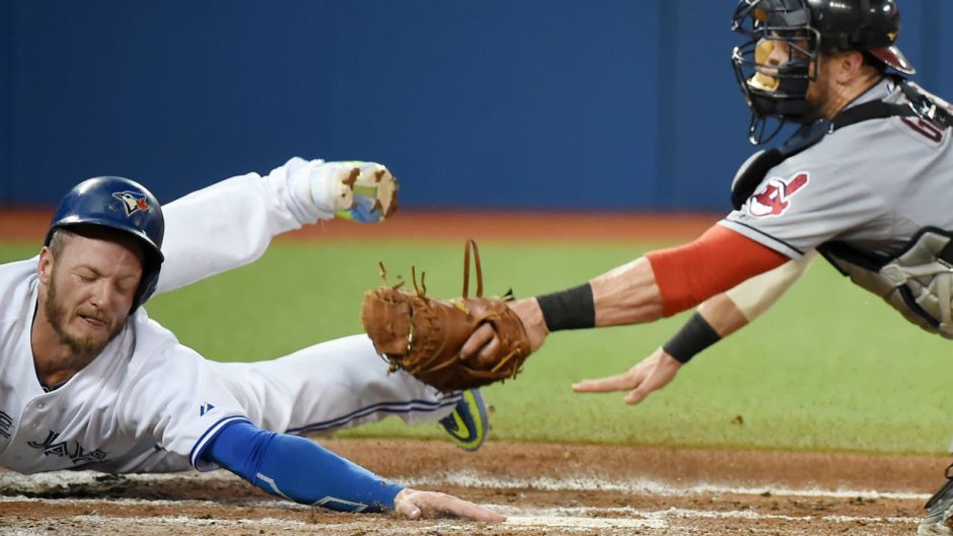 Sep 2, 2015; Toronto, Ontario, CAN; Toronto Blue Jays third baseman Josh Donaldson (20) eludes the tag of Cleveland Indians catcher Yan Gomes (10) to score in the second inning at Rogers Centre. Mandatory Credit: Dan Hamilton-USA TODAY Sports