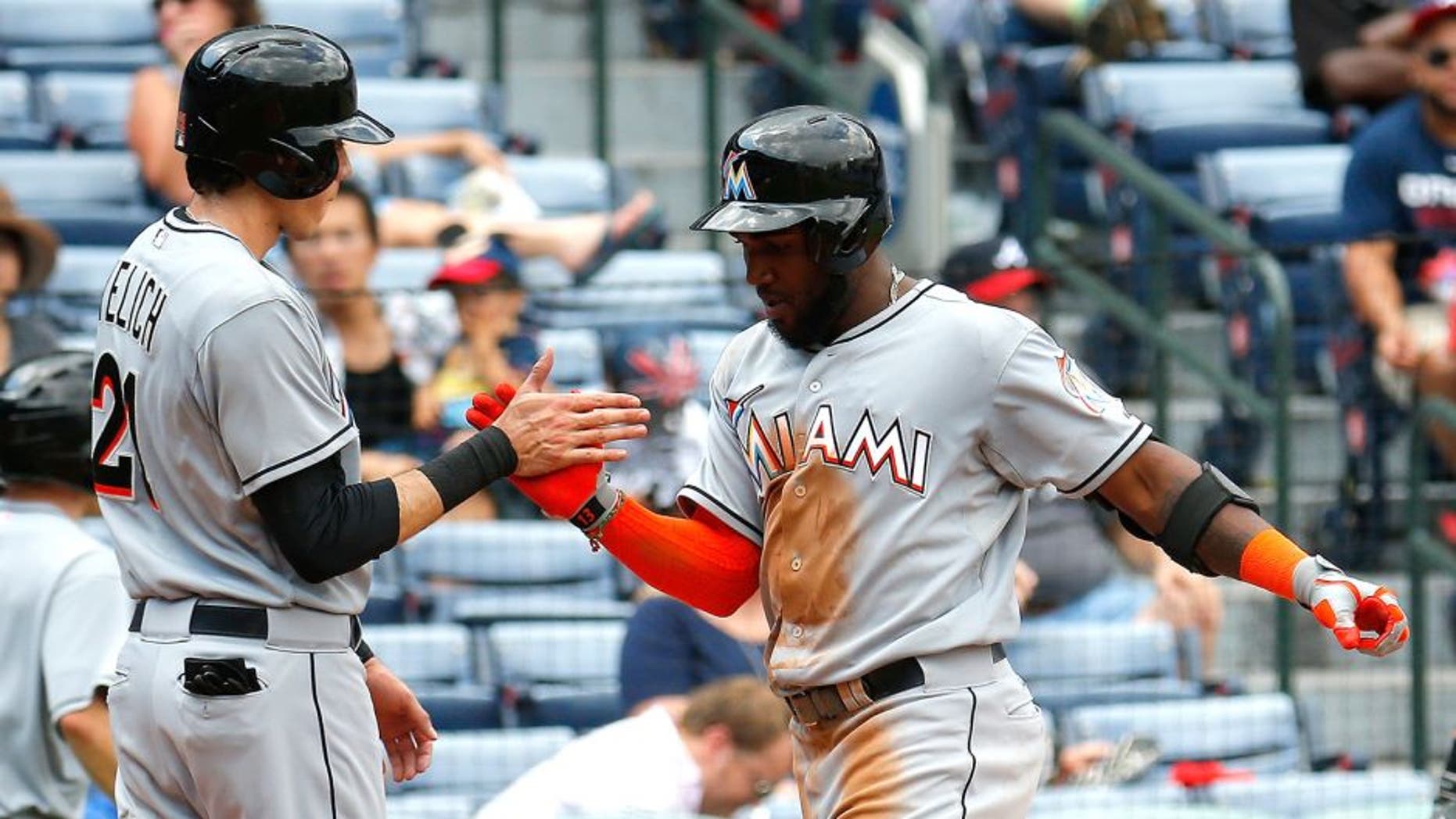 ATLANTA, GA - SEPTEMBER 02: Marcell Ozuna #13 of the Miami Marlins celebrates with Christian Yelich #21 after hitting a two-run homer in the fifth inning against the Atlanta Braves at Turner Field on September 2, 2015 in Atlanta, Georgia. (Photo by Kevin C. Cox/Getty Images)