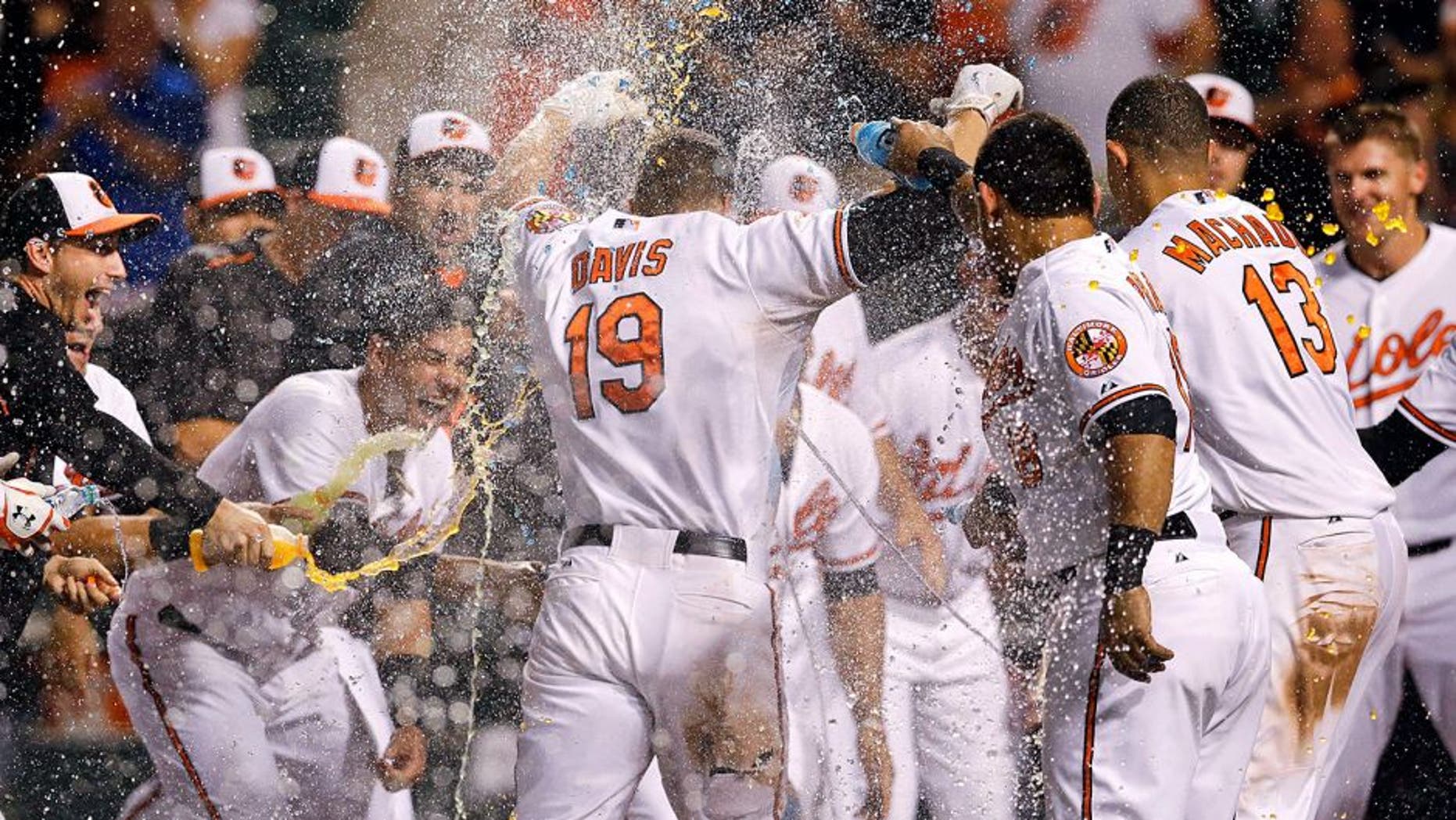 Baltimore Orioles' Chris Davis (19) is greeted as he crosses home plate after hitting a solo home run during the 11th inning of a baseball game against the Tampa Bay Rays, Wednesday, Sept. 2, 2015, in Baltimore. Baltimore won 7-6. (AP Photo/Patrick Semansky)