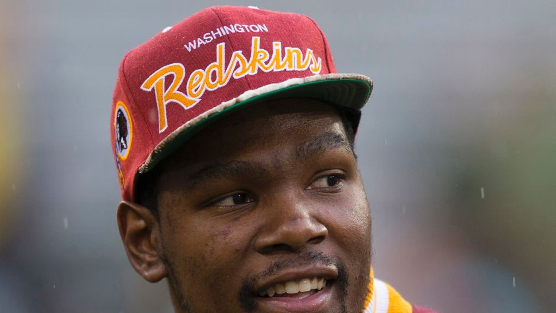 Sep 15, 2013; Green Bay, WI, USA; NBA player Kevin Durant looks on during warmups prior to the game between the Washington Redskins and Green Bay Packers at Lambeau Field. Mandatory Credit: Jeff Hanisch-USA TODAY Sports