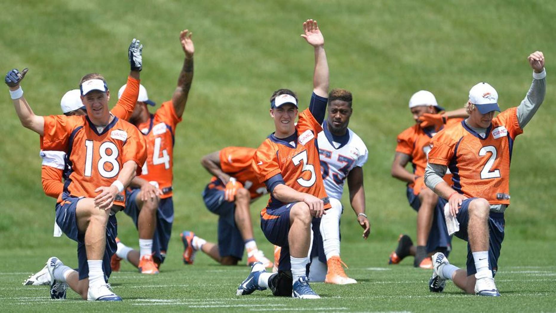 June 9, 2015; Englewood, CO, USA; Denver Broncos quarterback Peyton Manning (18) and quarterback Trevor Siemian (3) and quarterback Zac Dysert (2) warm up before the start of mini camp activities at the Broncos training facility. Mandatory Credit: Ron Chenoy-USA TODAY Sports