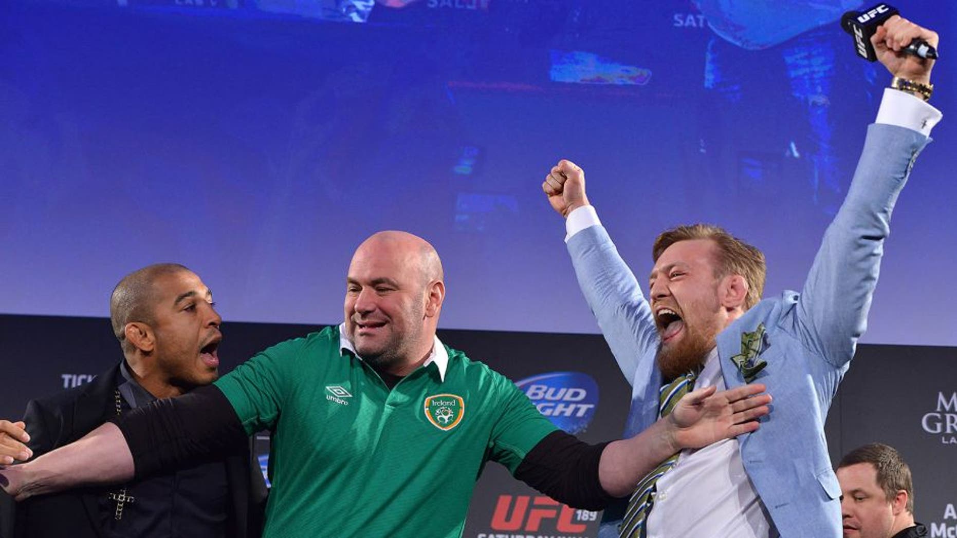 DUBLIN, IRELAND - MARCH 31: UFC featherweight title challenger Conor 'The Notorious' McGregor (R) steals UFC Featherweight Champion Jose Aldo's (L) belt as UFC President Dana White (C) separates the two during the UFC 189 World Championship Fan Event on March 31, 2015 in Dublin, Ireland. (Photo by Jeff Bottari/Zuffa LLC/Zuffa LLC via Getty Images)