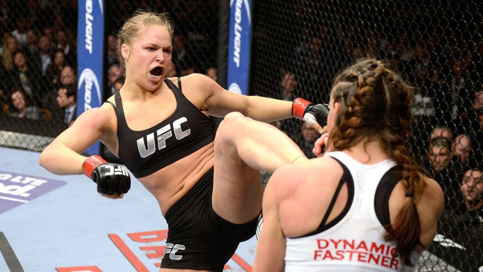 LAS VEGAS, NV - DECEMBER 28: (L-R) Ronda Rousey kicks Miesha Tate in their UFC women's bantamweight championship bout during the UFC 168 event at the MGM Grand Garden Arena on December 28, 2013 in Las Vegas, Nevada. (Photo by Donald Miralle/Zuffa LLC/Zuffa LLC via Getty Images)