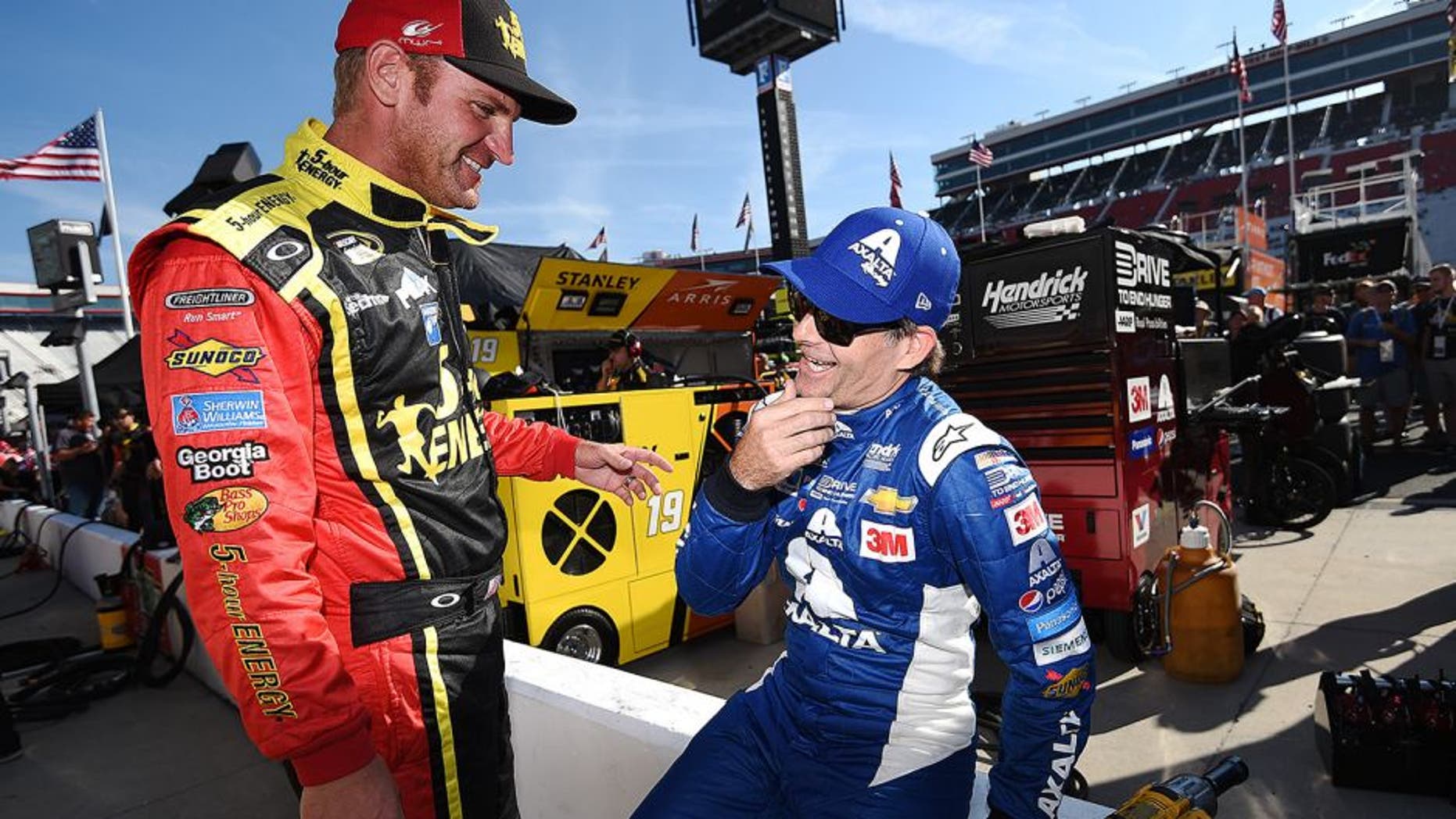 BRISTOL, TN - AUGUST 21: Clint Bowyer, driver of the #15 5-hour Energy Toyota, talks to Jeff Gordon, driver of the #24 Axalta Chevrolet, on the grid during qualifying for the NASCAR Sprint Cup Series Irwin Tools Night Race at Bristol Motor Speedway on August 21, 2015 in Bristol, Tennessee. (Photo by Rainier Ehrhardt/NASCAR via Getty Images)
