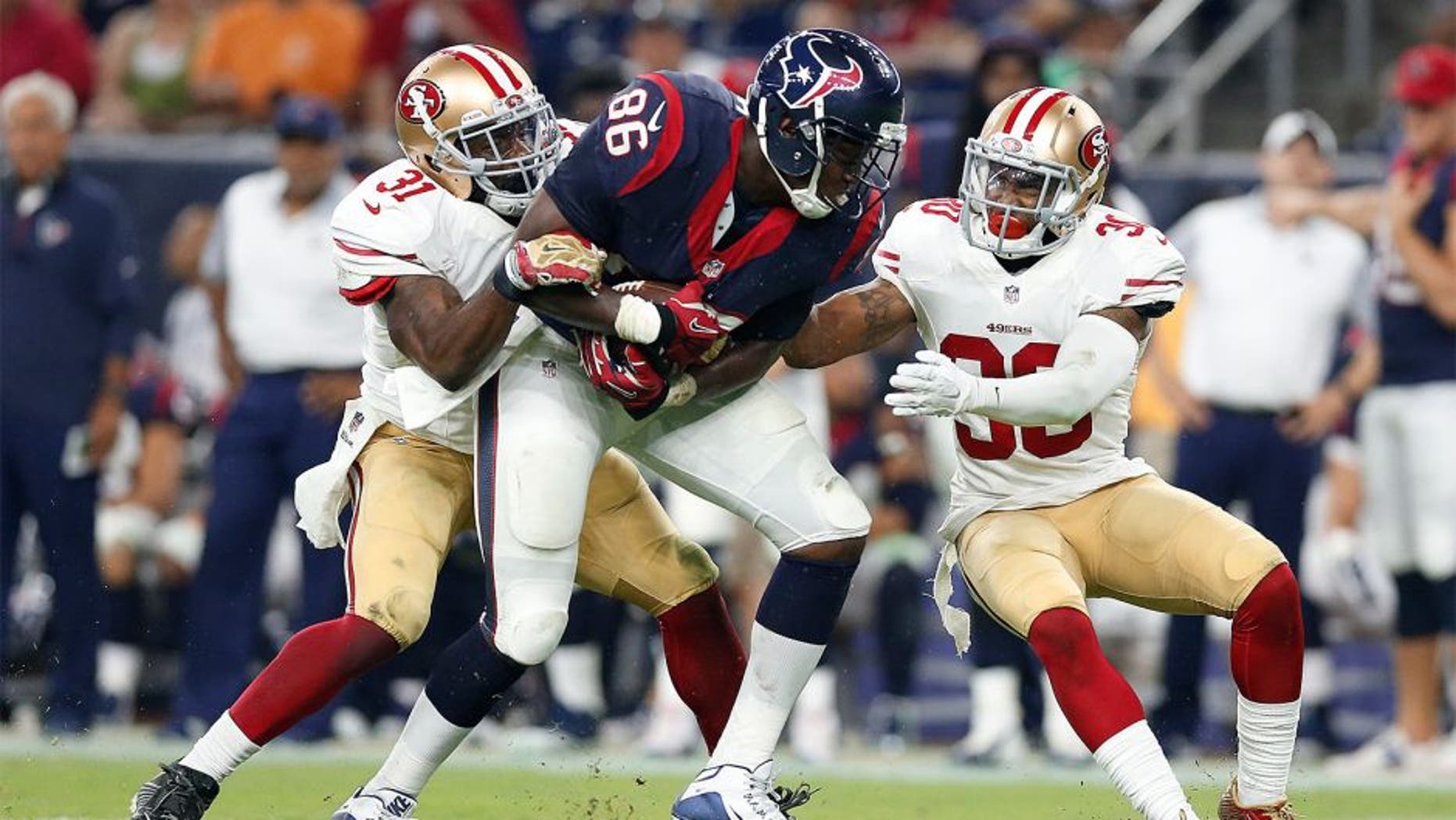 Aug 15, 2015; Houston, TX, USA; Houston Texans tight end Khari Lee (86) runs after a reception against San Francisco 49ers safety L.J. McCray (31) and cornerback Leon McFadden (30) in a preseason NFL football game at NRG Stadium. The Texans beat the 49ers 23-10. Mandatory Credit: Matthew Emmons-USA TODAY Sports