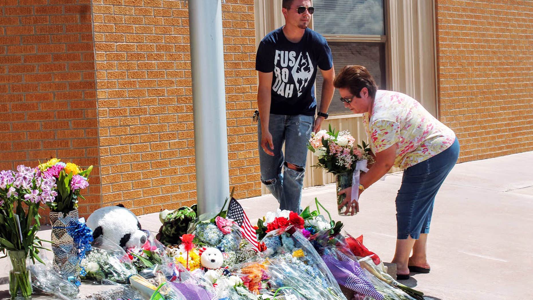 Sept. 2, 2016: Residents add to a sidewalk memorial outside Alamogordo, N.M., police headquarters.