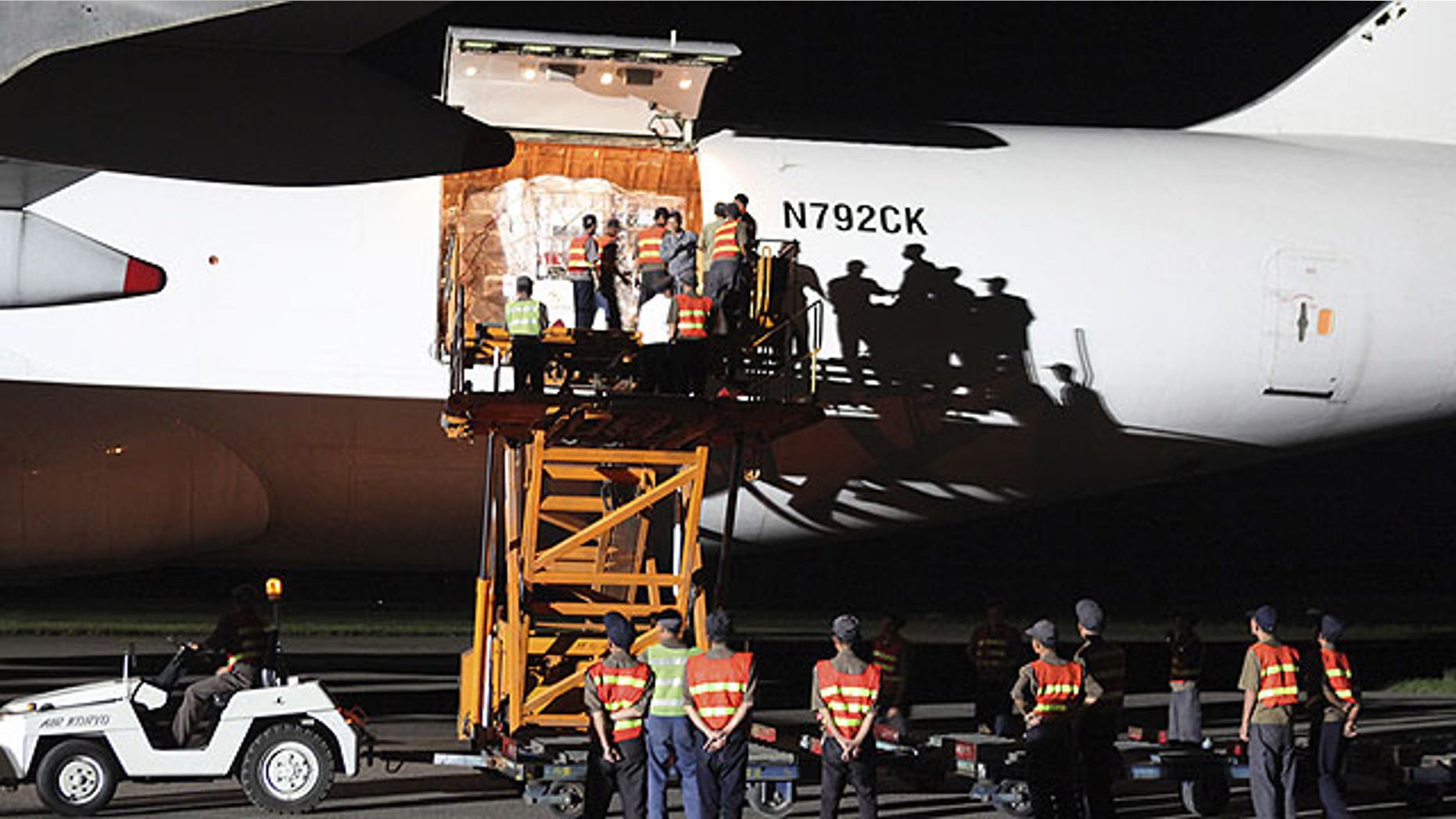 September 3: North Korean workers unload emergency aid sent from the United States from a plane upon arrival at Pyongyang airport, North Korea.