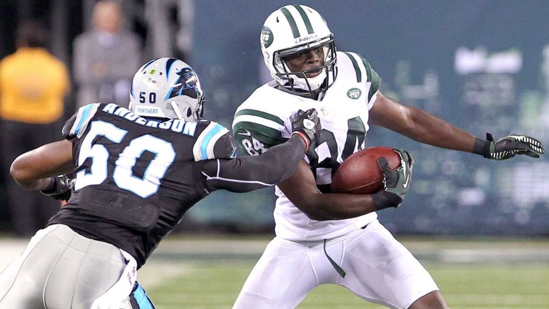 Aug 26, 2012; East Rutherford, NJ, USA; New York Jets wide receiver Stephen Hill (84) tries to avoid Carolina Panthers linebacker James Anderson (50) during the second half at MetLife Stadium. The Panthers defeated the Jets 17-12. Mandatory Credit: Ed Mulholland-USA TODAY Sports