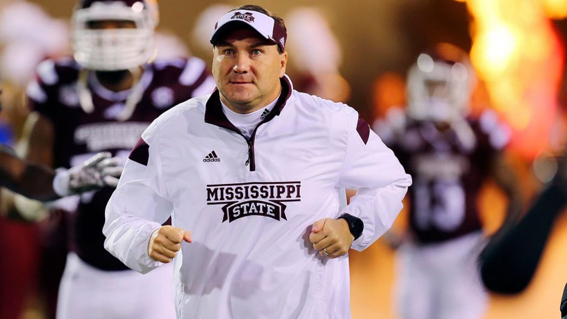 Nov 22, 2014; Starkville, MS, USA; Mississippi State Bulldogs head coach Dan Mullen runs onto the field before the game between the Mississippi State Bulldogs and the Vanderbilt Commodores at Davis Wade Stadium. Mandatory Credit: Spruce Derden-USA TODAY Sports