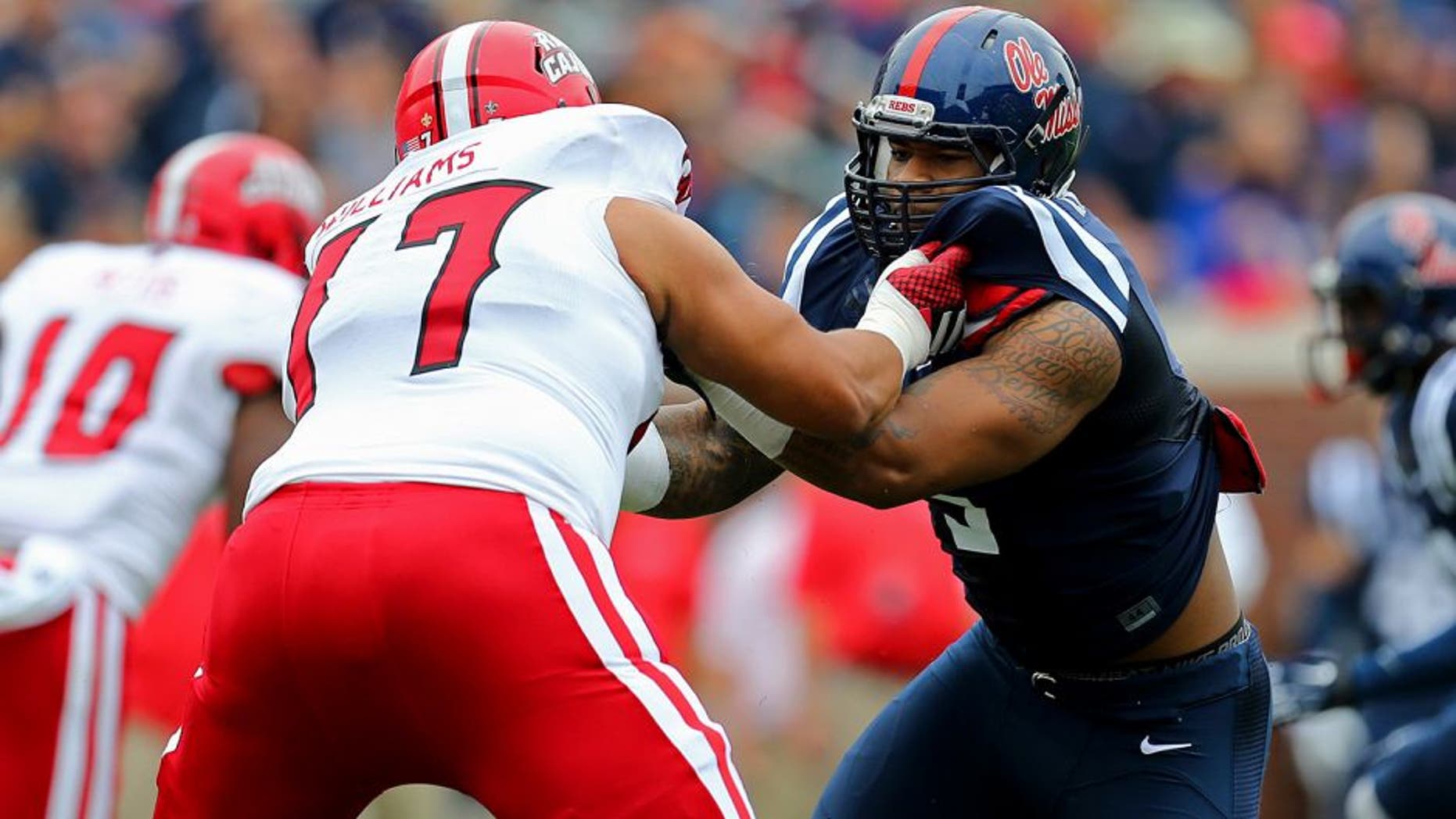 Sep 13, 2014; Oxford, MS, USA; Mississippi Rebels defensive tackle Robert Nkemdiche (5) fights at the line with Louisiana-Lafayette Ragin Cajuns offensive linesman Donovan Williams (77) during the game at Vaught-Hemingway Stadium. Mandatory Credit: Spruce Derden-USA TODAY Sports