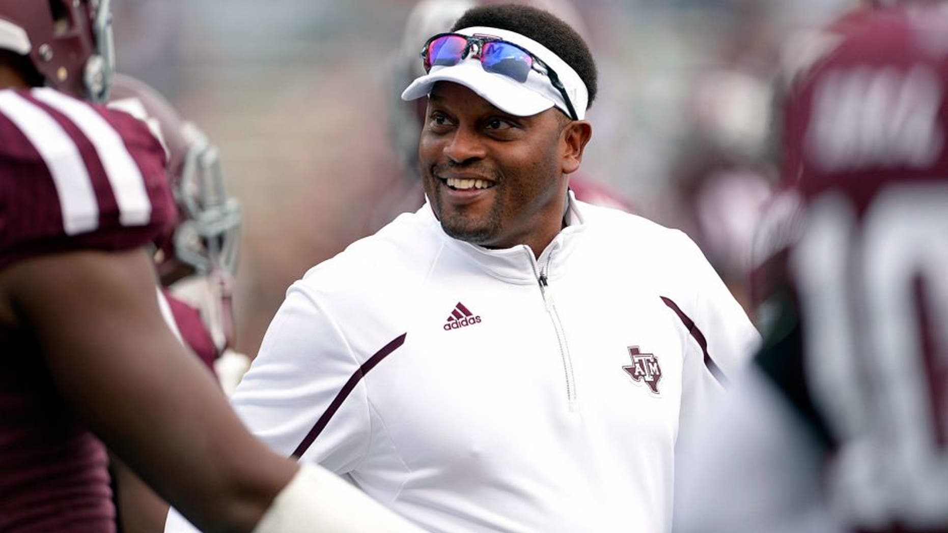 Nov 9, 2013; College Station, TX, USA; Texas A&M Aggies head coach Kevin Sumlin coaches before the game against the Mississippi State Bulldogs at Kyle Field. Mandatory Credit: Thomas Campbell-USA TODAY Sports