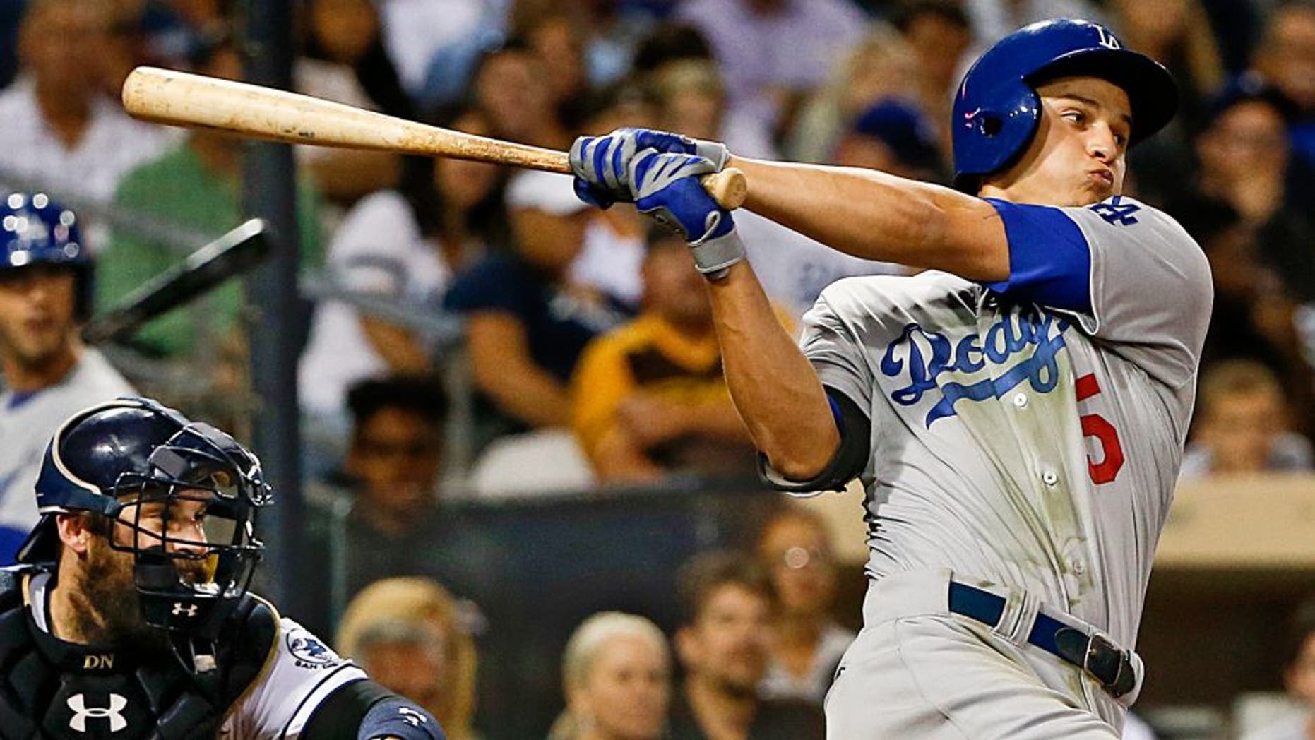 Los Angeles Dodgers' Corey Seager follows through with his second hit in his major league debut, during the sixth inning of a baseball game against the San Diego Padres on Thursday, Sept. 3, 2015, in San Diego. (AP Photo/Lenny Ignelzi)