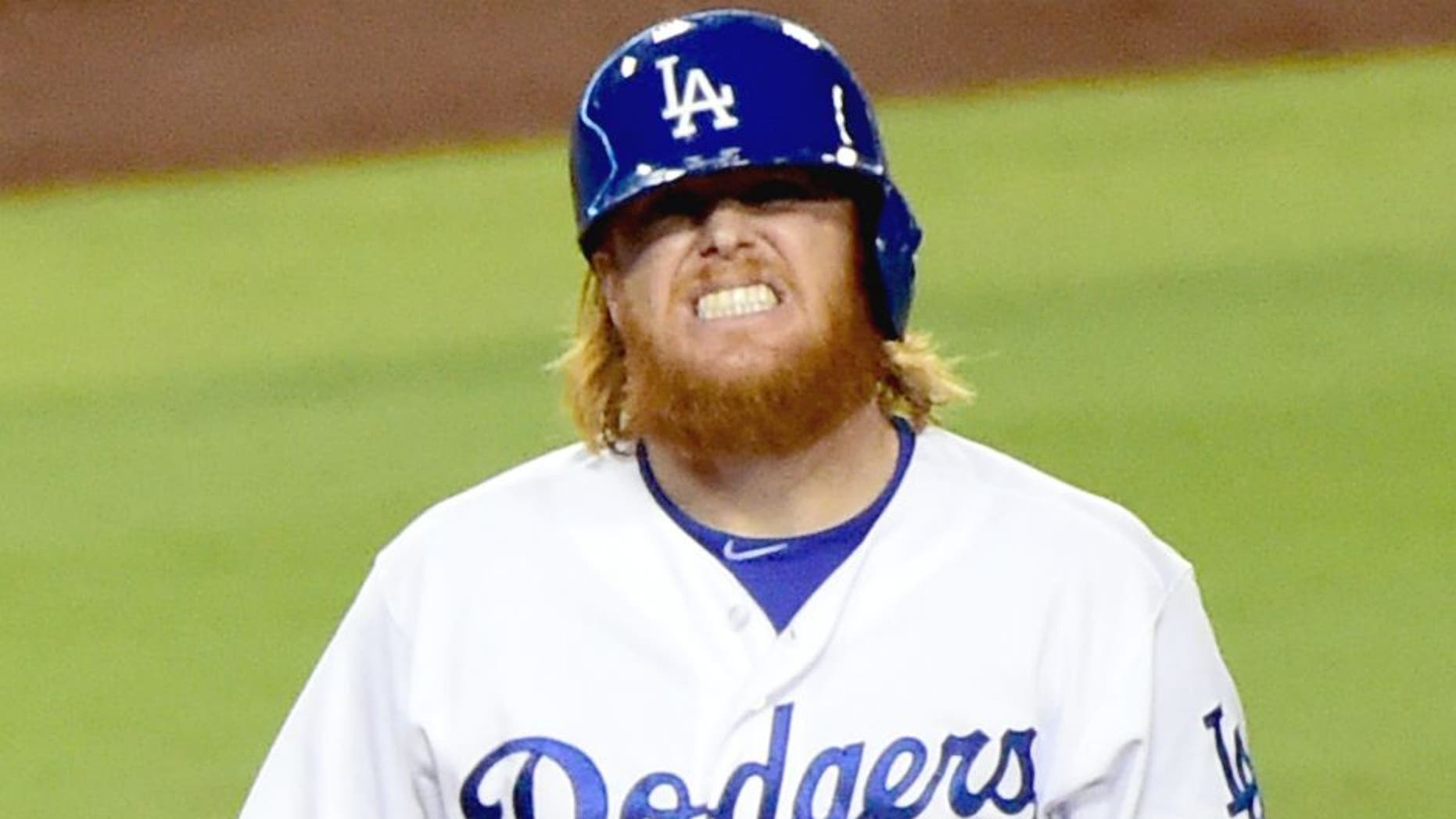 LOS ANGELES, CA - SEPTEMBER 02: Justin Turner #10 of the Los Angeles Dodgers grimaces after he is hit by a pitch during the fourth inning against the San Francisco Giants at Dodger Stadium on September 2, 2015 in Los Angeles, California. (Photo by Harry How/Getty Images)