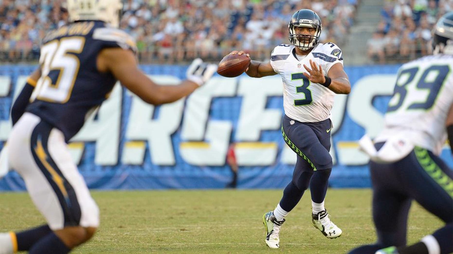 Aug 29, 2015; San Diego, CA, USA; Seattle Seahawks quarterback Russell Wilson (3) looks to pass during the third quarter against the San Diego Chargers at Qualcomm Stadium. Mandatory Credit: Jake Roth-USA TODAY Sports
