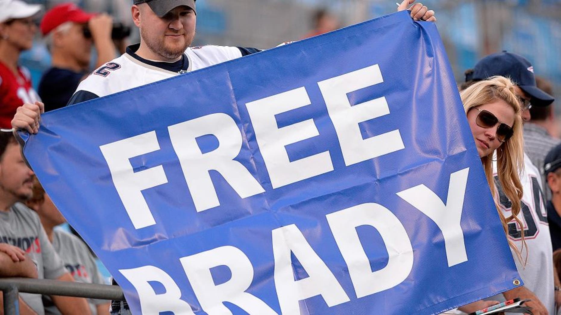 CHARLOTTE, NC - AUGUST 28: Fans hold up a sign in support of Tom Brady #12 of the New England Patriots during their preseason NFL game against the Carolina Panthers at Bank of America Stadium on August 28, 2015 in Charlotte, North Carolina. (Photo by Grant Halverson/Getty Images)