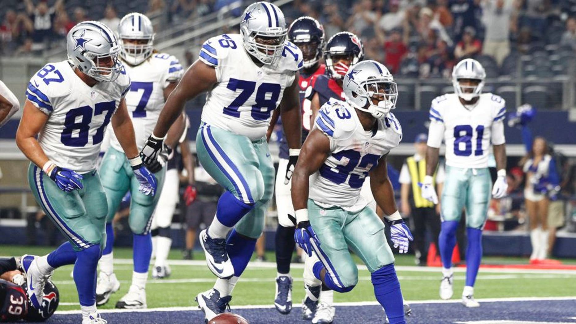 Sep 3, 2015; Arlington, TX, USA; Dallas Cowboys running back Ben Malena (33) celebrates scoring a touchdown in the fourth quarter against the Houston Texans at AT&T Stadium. Dallas won 21-14. Mandatory Credit: Tim Heitman-USA TODAY Sports