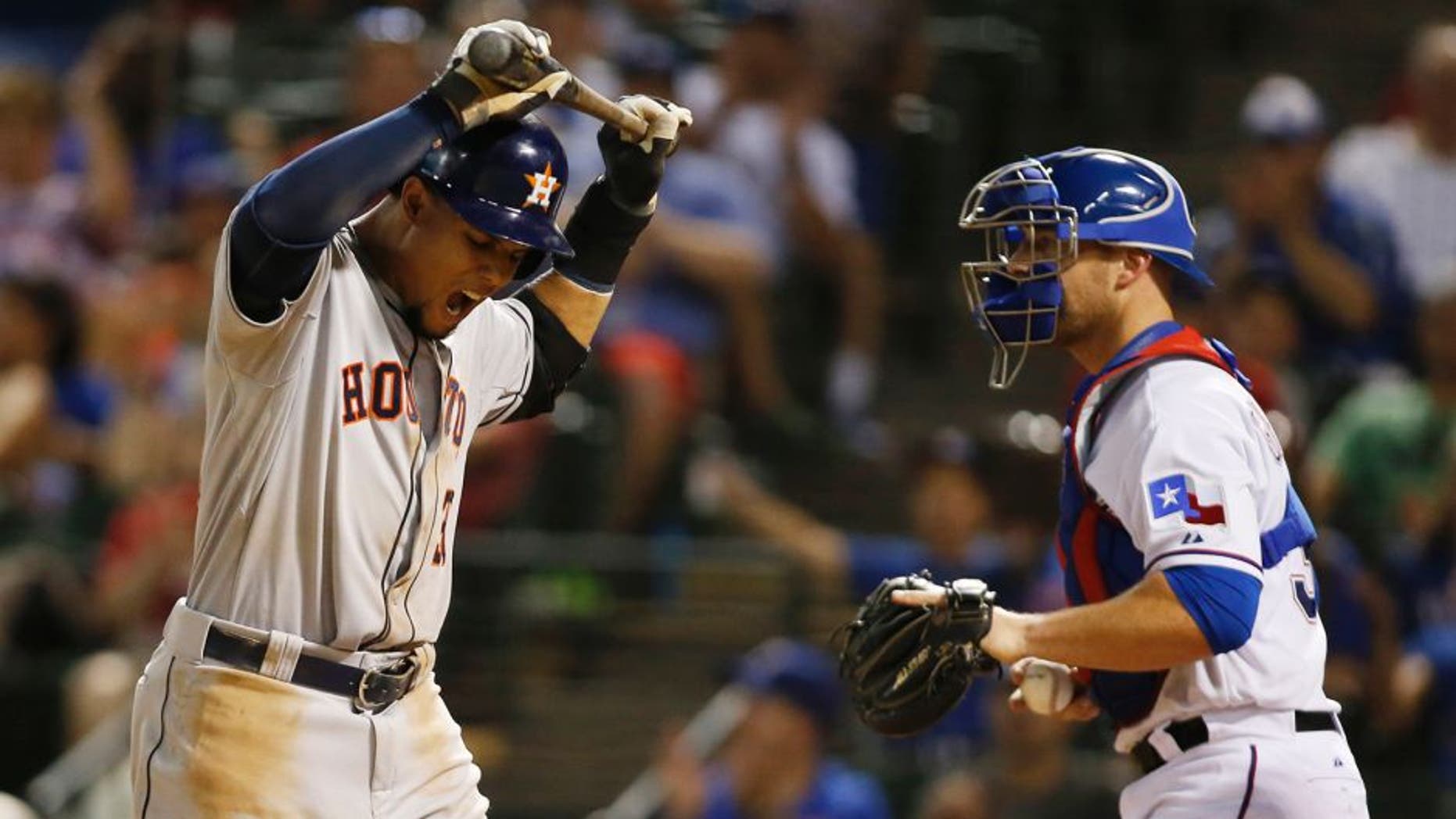 Aug 5, 2015; Arlington, TX, USA; Houston Astros center fielder Carlos Gomez (30) reacts to striking out in the ninth inning as Texas Rangers catcher Chris Gimenez (38) looks on at Globe Life Park in Arlington. Texas won 4-3. Mandatory Credit: Tim Heitman-USA TODAY Sports