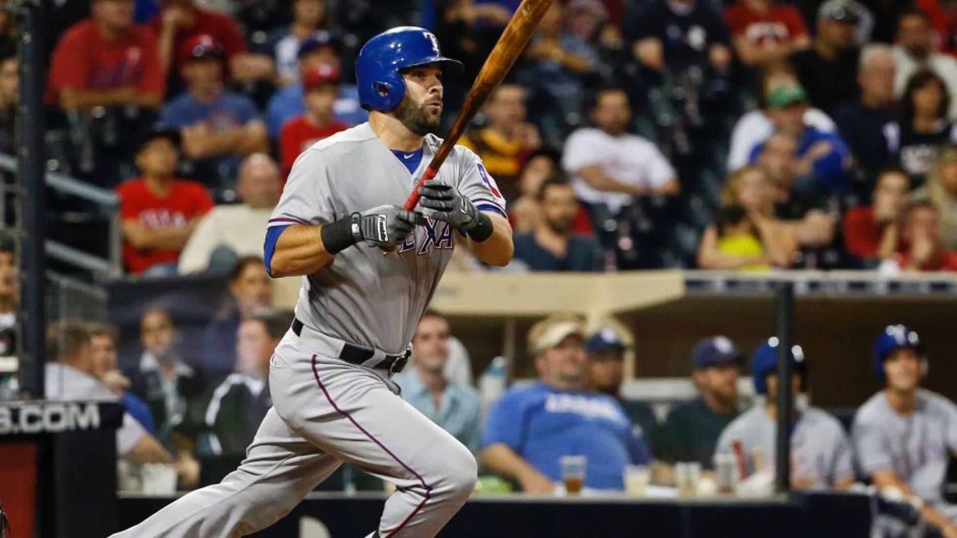 Texas Rangers' Mitch Moreland watches his run producing double just stay fair down the right field line in the tenth inning of a baseball game against the San Diego Padres Wednesday, Sept. 2, 2015, in San Diego. (AP Photo/Lenny Ignelzi)