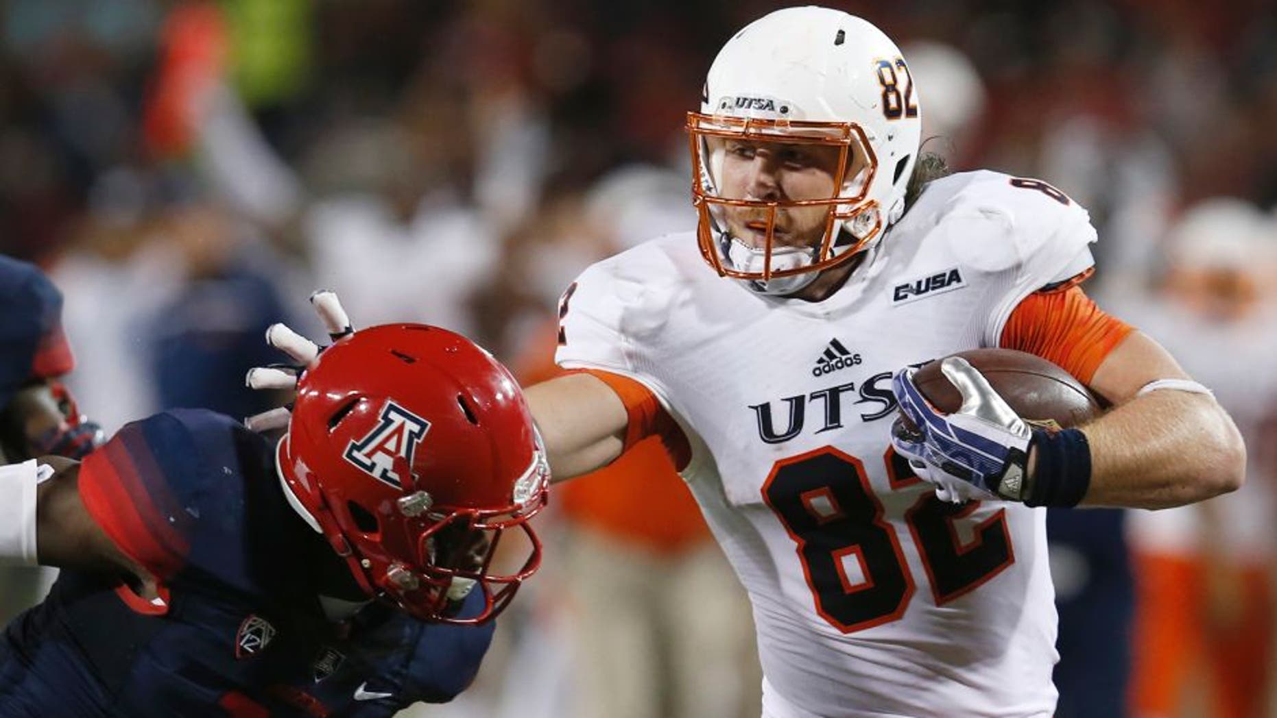 UTSA tight end David Morgan II (82) stiff arms Arizona safety Will Parks during the first half of an NCAA college football game, Thursday, Sept. 3, 2015, in Tucson, Ariz. (AP Photo/Rick Scuteri)