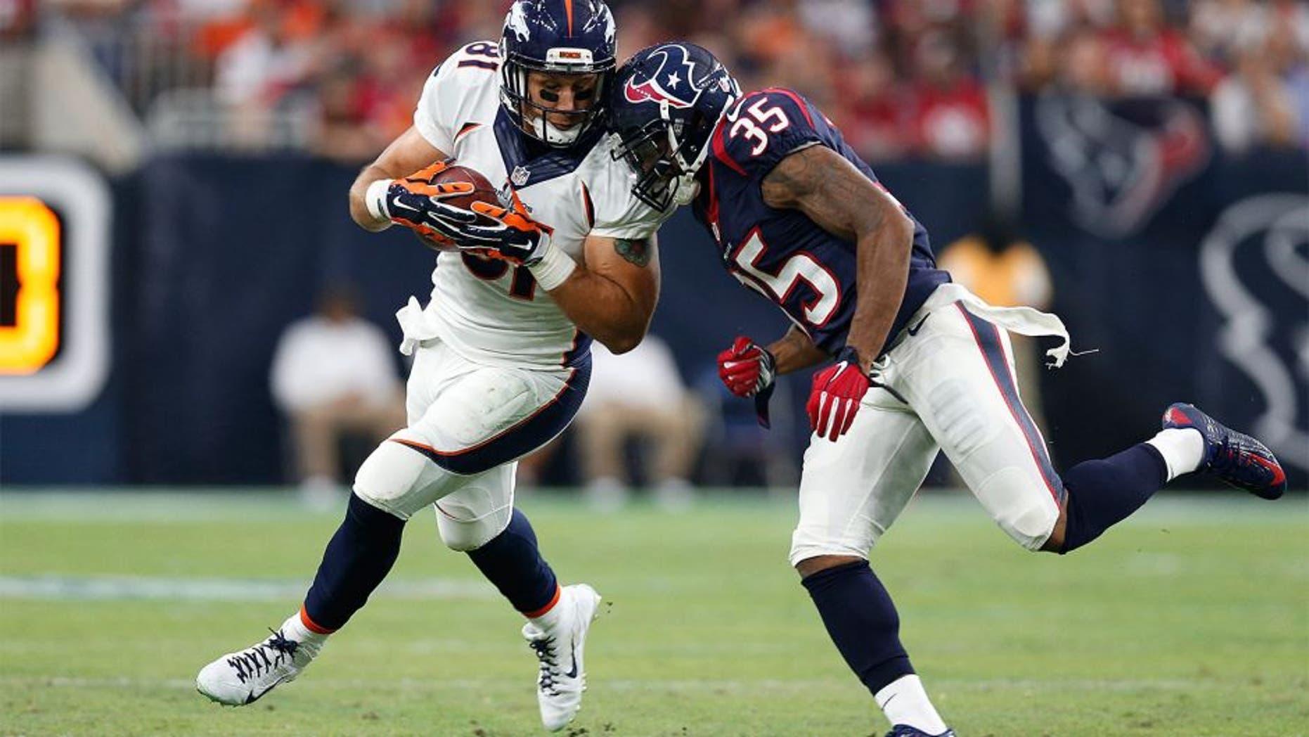 Aug 22, 2015; Houston, TX, USA; Denver Broncos tight end Owen Daniels (81) is tackled after a reception by Houston Texans safety Eddie Pleasant (35) at NRG Stadium. Mandatory Credit: Matthew Emmons-USA TODAY Sports