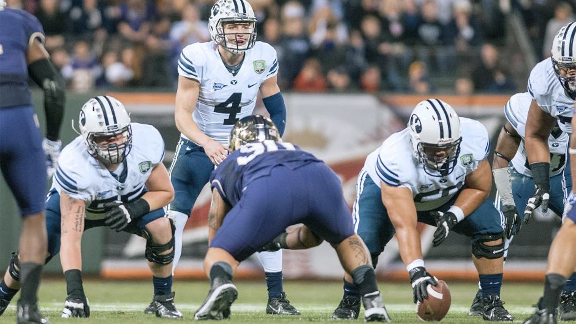 Dec 27, 2013; San Francisco, CA, USA; Brigham Young Cougars quarterback Taysom Hill (4) prepares to hike the ball against the Washington Huskies during the second quarter at AT&T Park. Mandatory Credit: Ed Szczepanski-USA TODAY Sports