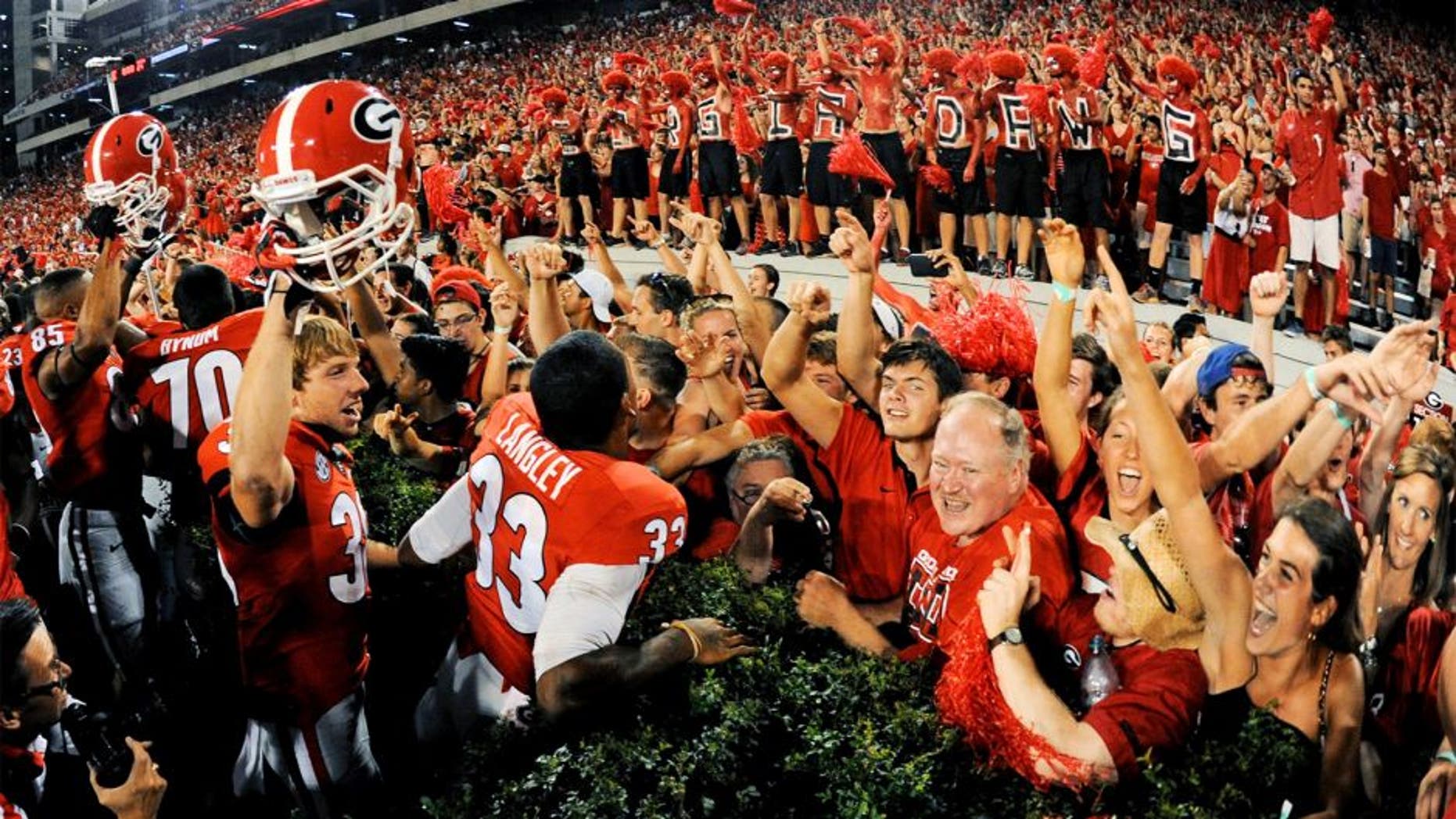 Aug 30, 2014; Athens, GA, USA; Georgia Bulldogs players and fans react after defeating the Clemson Tigers at Sanford Stadium. Georgia defeated Clemson 45-21. Mandatory Credit: Dale Zanine-USA TODAY Sports