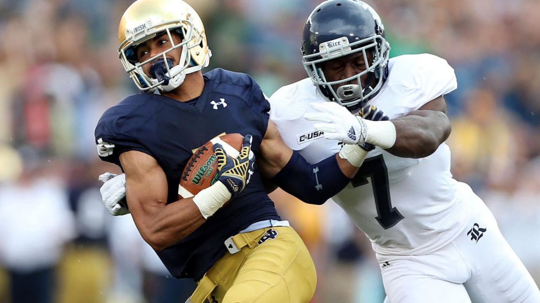 Aug 30, 2014; South Bend, IN, USA; Notre Dame Fighting Irish wide receiver Will Fuller (7) catches a pass for a 75 yard touchdown against Rice Owls safety Julius White (7) at Notre Dame Stadium. Mandatory Credit: Brian Spurlock-USA TODAY Sports
