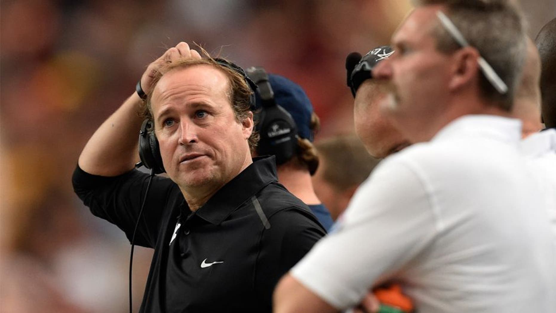 Aug 30, 2014; Atlanta, GA, USA; West Virginia Mountaineers head coach Dana Holgorsen watches his team against the Alabama Crimson Tide in the second quarter of the 2014 Chick-fil-A Kickoff Game at the Georgia Dome. Mandatory Credit: RVR Photos-USA TODAY Sports