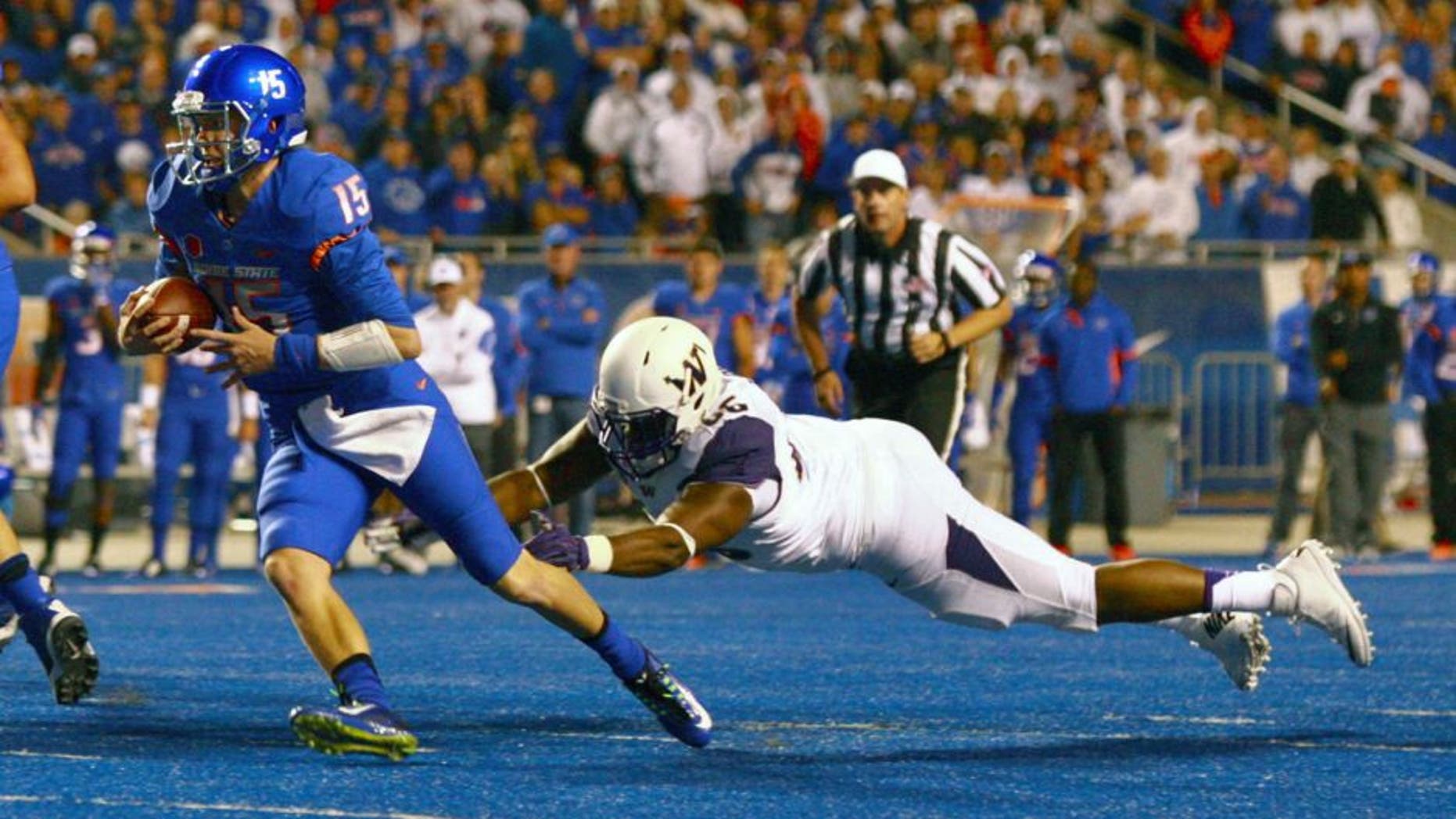 Sep 4, 2015; Boise, ID, USA; Boise State Broncos quarterback Ryan Finley (15) runs away from Washington Huskies defensive lineman Damion Turpin (66) during the first half at Albertsons Stadium. Mandatory Credit: Brian Losness-USA TODAY Sports