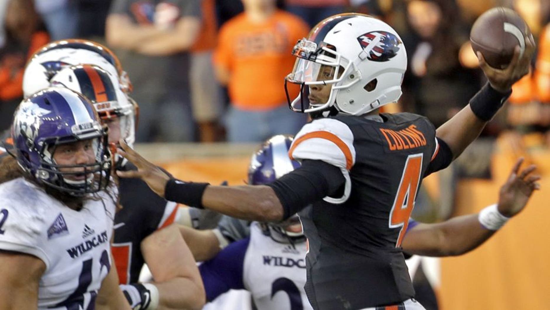 Oregon State quarterback Seth Collins, right, throws as Weber State defensive lineman Jonathan Carlson watches during the second half of an NCAA college football in Corvallis, Ore., Friday, Sept. 4, 2015. Oregon State won 26-7. (AP Photo/Don Ryan)