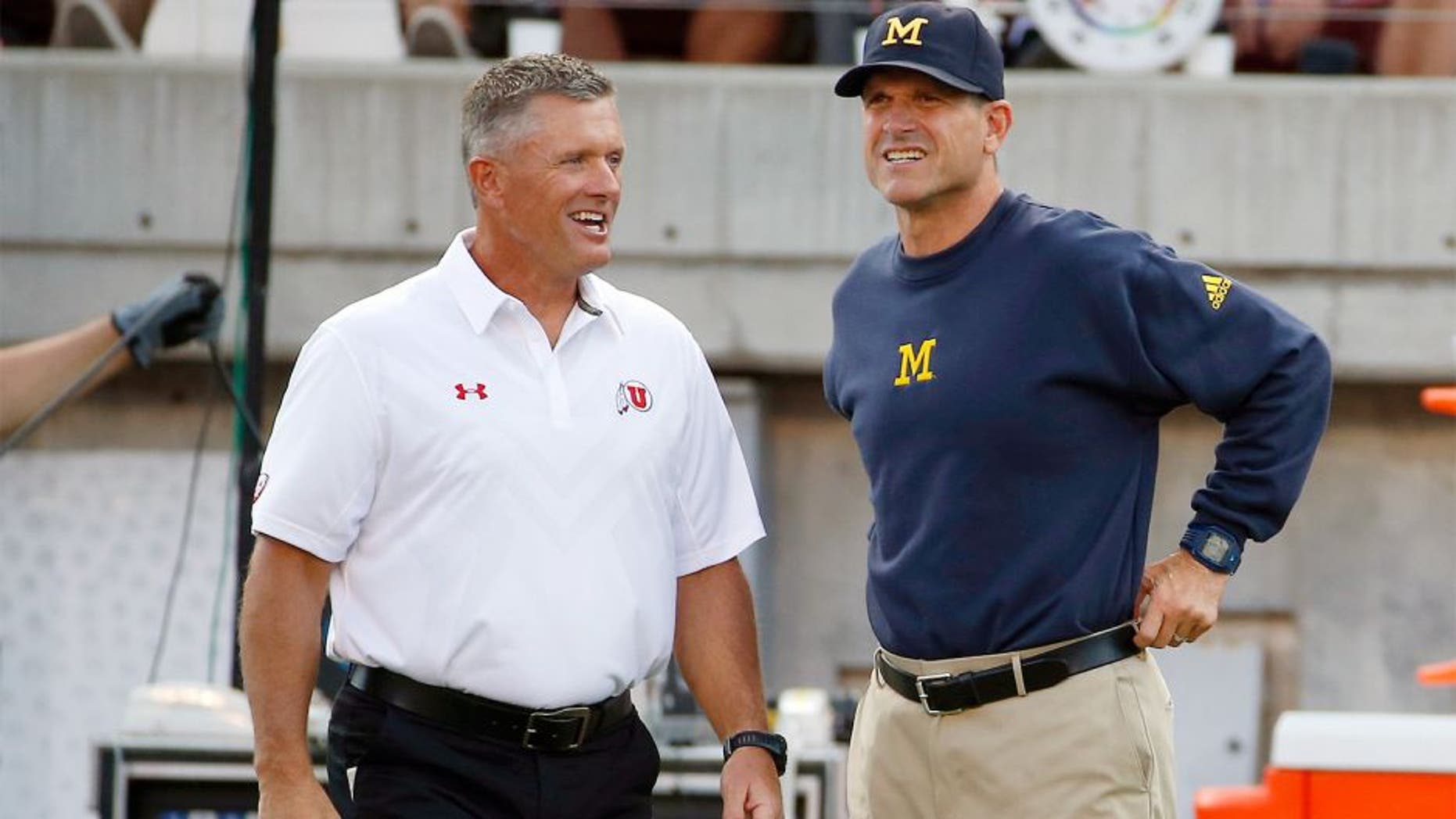 Sep 3, 2015; Salt Lake City, UT, USA; Utah Utes head coach Kyle Whittingham (left) and Michigan Wolverines head coach Jim Harbaugh get together prior to their game at Rice-Eccles Stadium. Mandatory Credit: Jeff Swinger-USA TODAY Sports