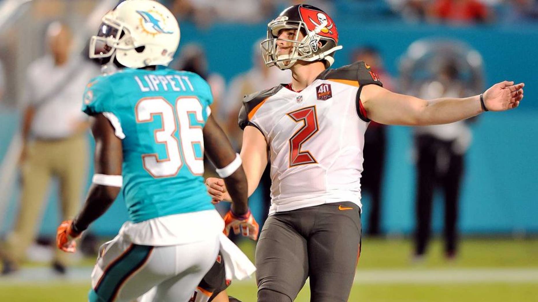 Sep 3, 2015; Miami Gardens, FL, USA; Tampa Bay Buccaneers kicker Kyle Brindza (2) kicks a field goal as Miami Dolphins defensive back Tony Lippett (36) looks on during the first half at Sun Life Stadium. Mandatory Credit: Steve Mitchell-USA TODAY Sports