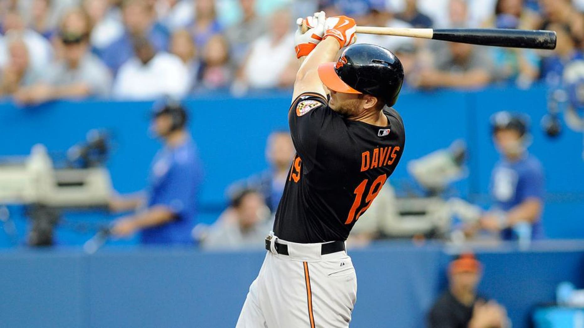 Sep 4, 2015; Toronto, Ontario, CAN; Baltimore Orioles first baseman Chris Davis (19) hits a home run against Toronto Blue Jays in the second inning at Rogers Centre. Mandatory Credit: Peter Llewellyn-USA TODAY Sports